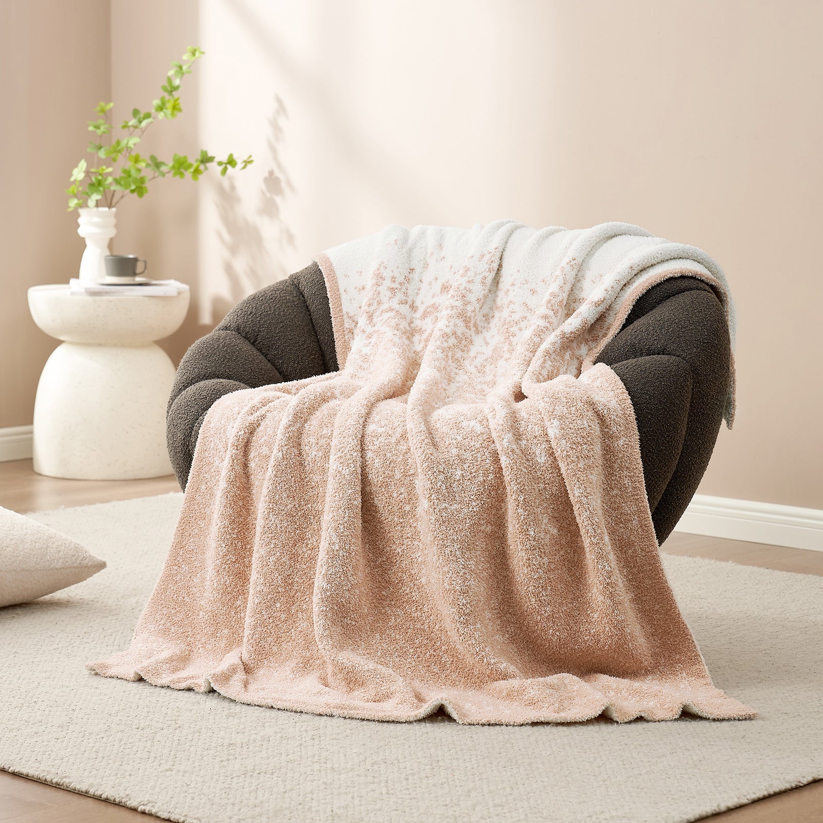Snuggle Sacs Reversible Ombre Heather Feather Yarn Knit Throw Blanket on a grey couch#color_Khaki
