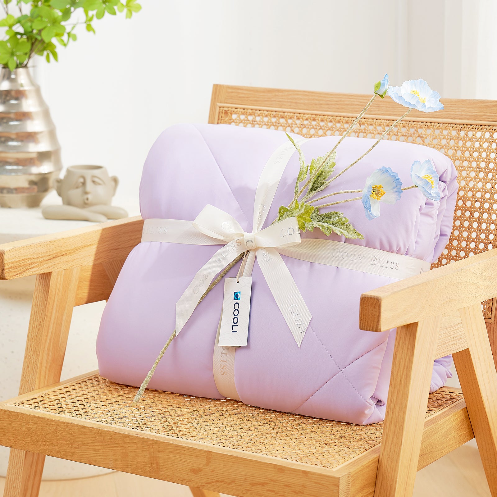 Cooling comforter with a white ribbon on a wooden chair, perfect as gift.#color_Purple