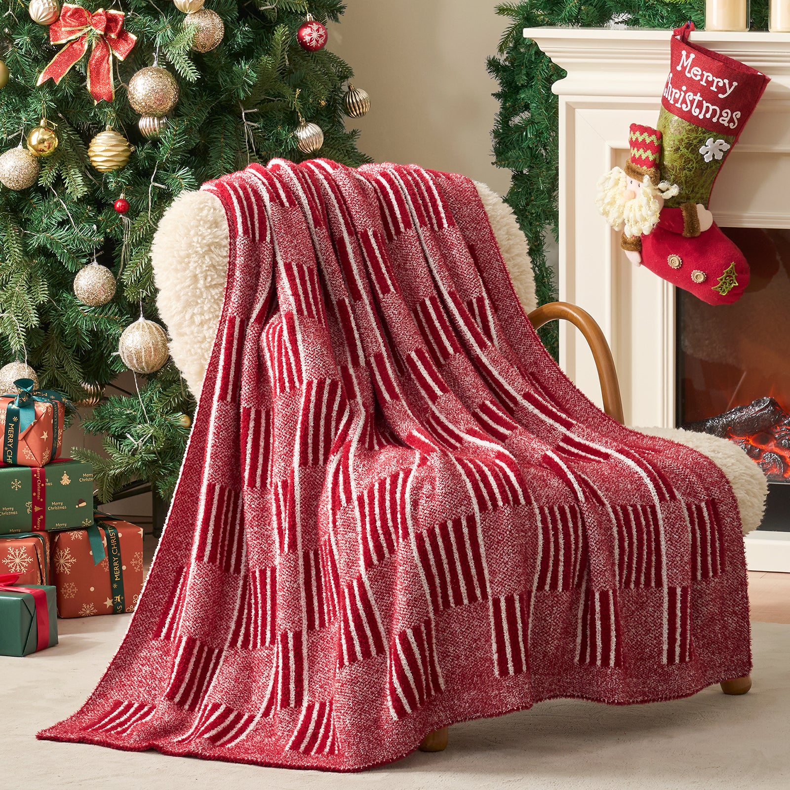 Red and white patterned blanket draped over a chair in a festive living room with Christmas tree and stockings. #color_Heather Red