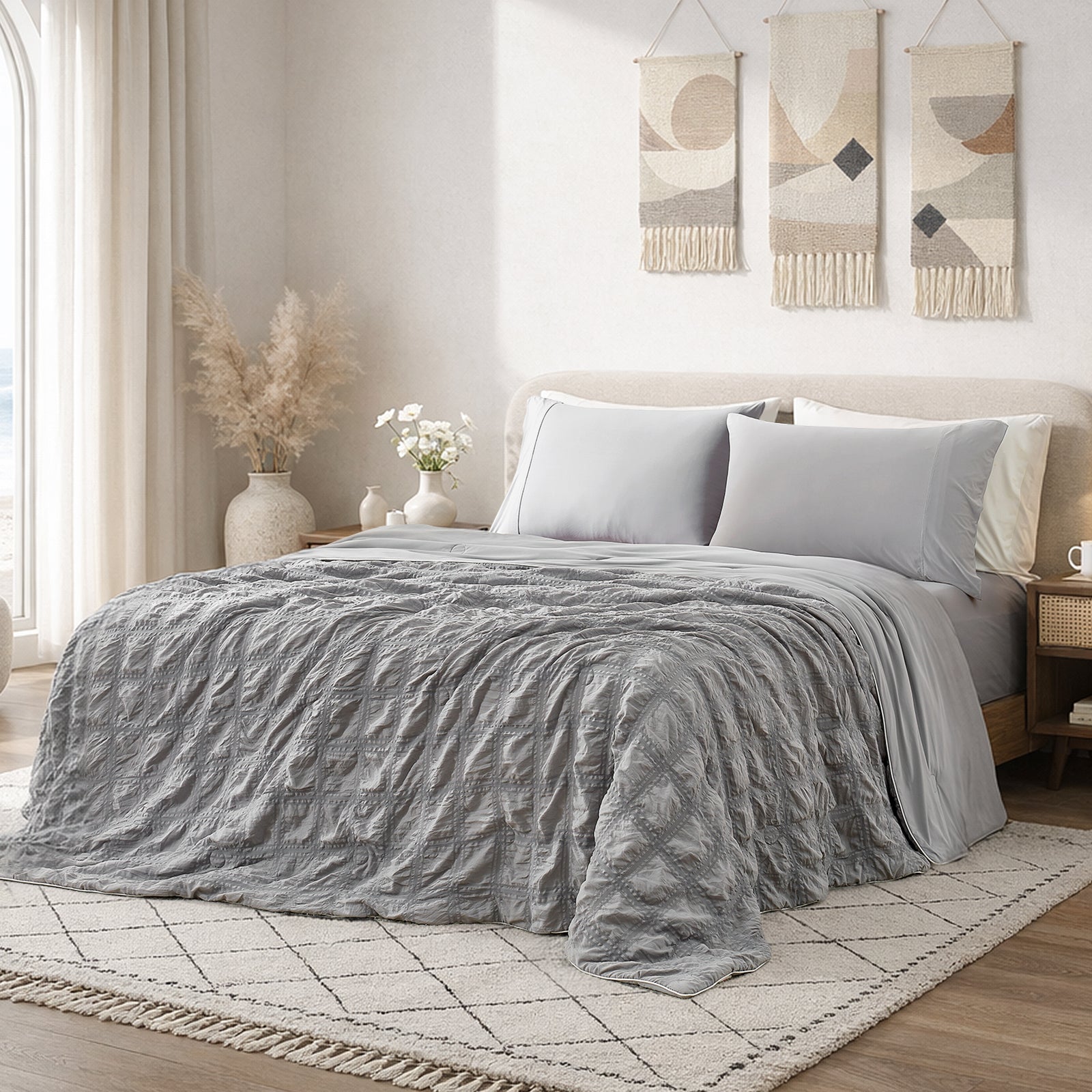 Snuggle Sac Cooling comforter in grey on bed in a bedroom with window,plant and a view behind#color_Grey