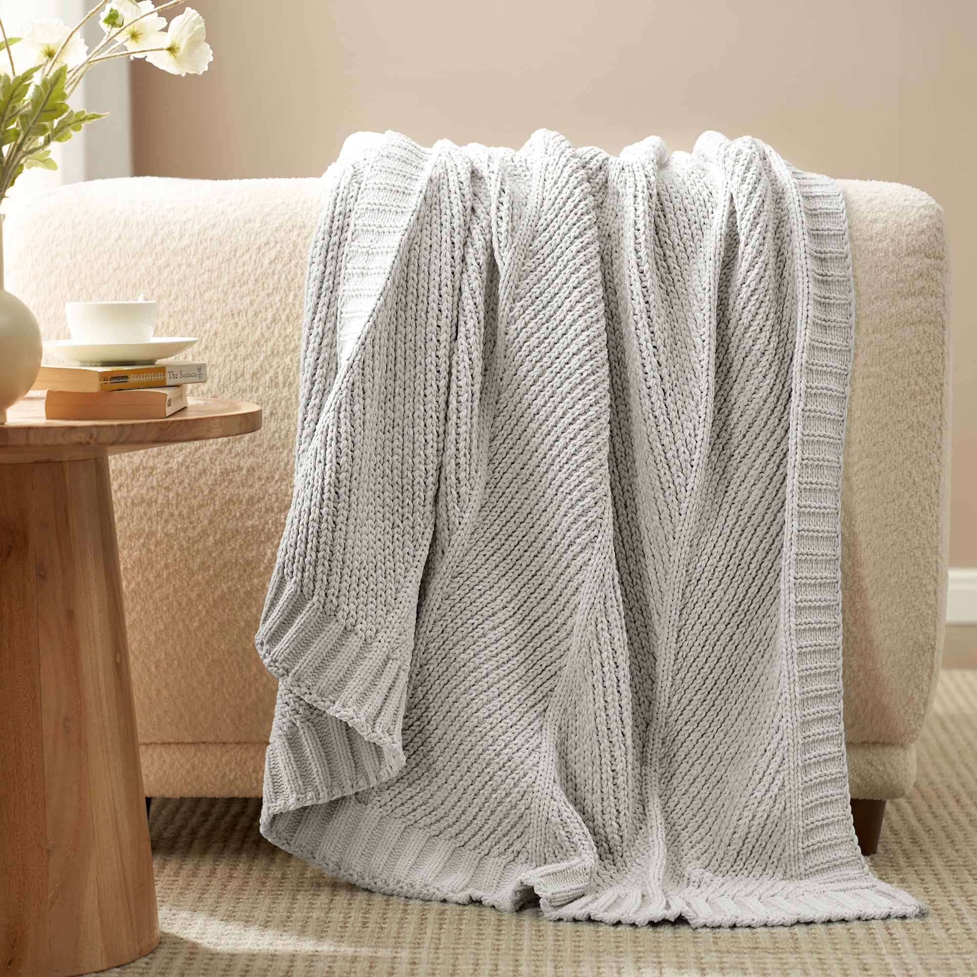 Snuggle Sac chevron chenille knit throw blanket in Light Grey draped over a sofa creating a warm and inviting look #color_Light Grey