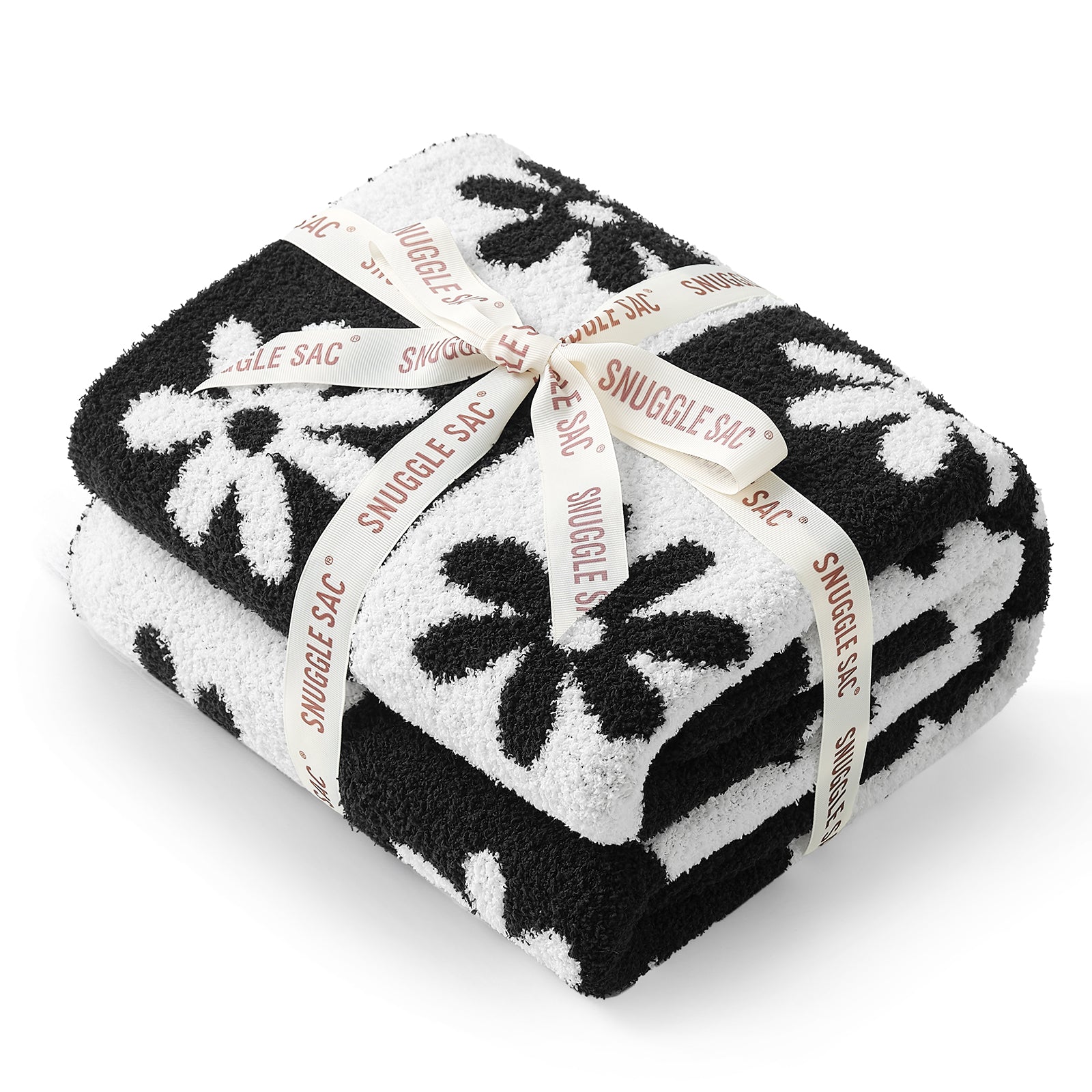 Black and white patterned blanket with 'Snuggle Sac' branding on a white background #color_Black