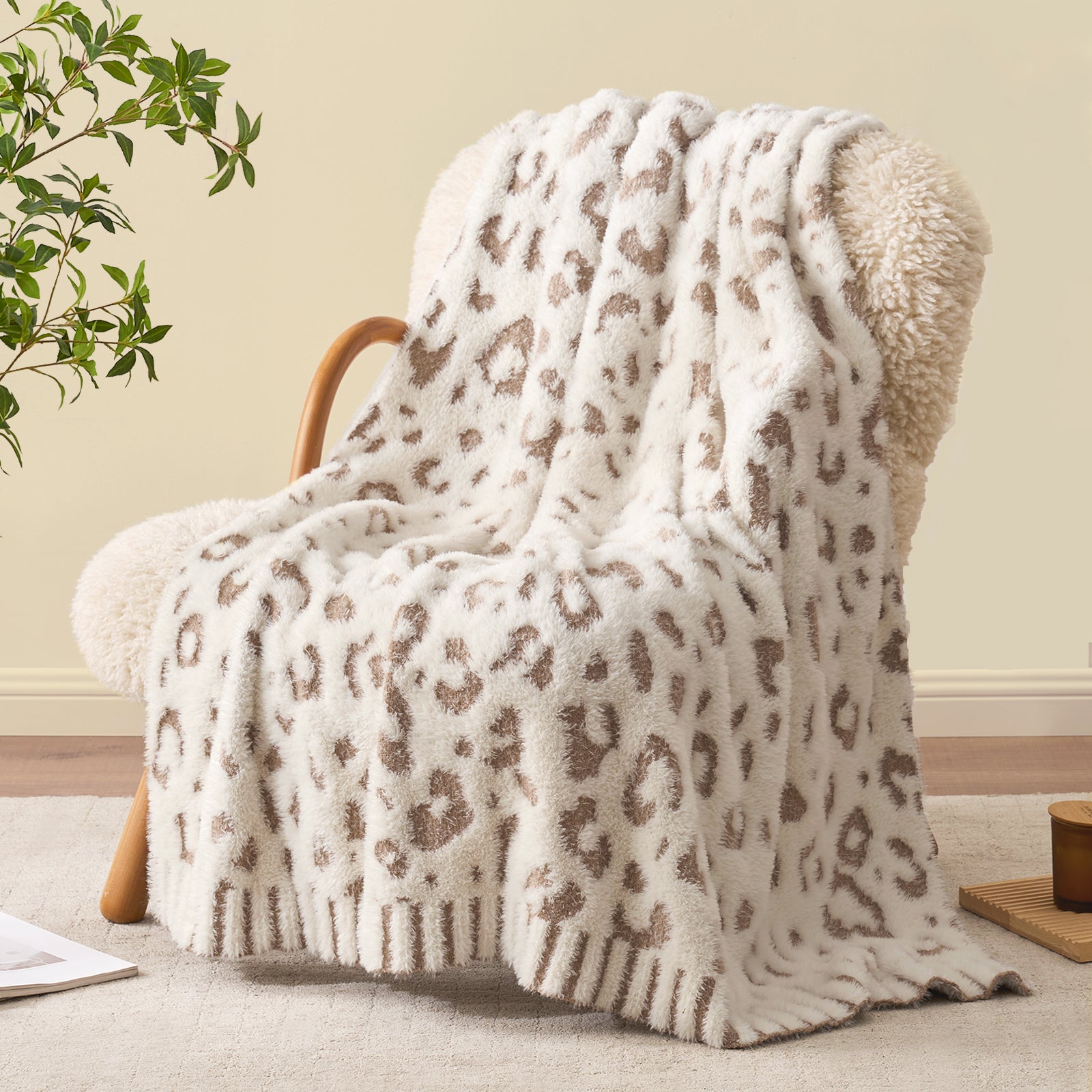 Snuggle Sac Leopard Faux Fur Knit Throw Blanket on a wooden chair.