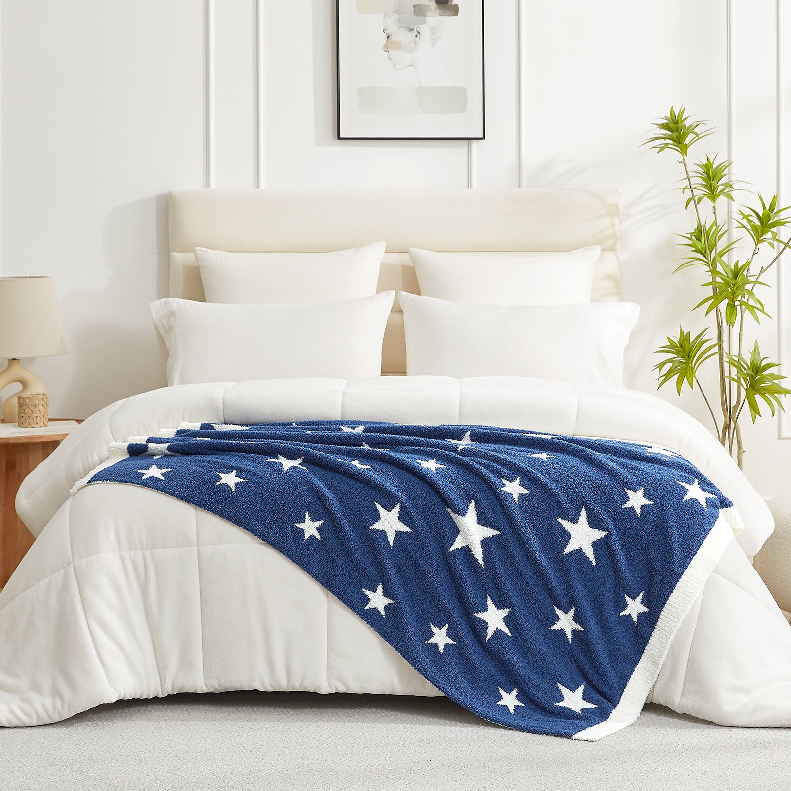 Snuggle Sacs Reversible Star Feather Yarn Knit Throw Blanket on a bed ina. bright room with plant#color_Royal_Heather_Blue