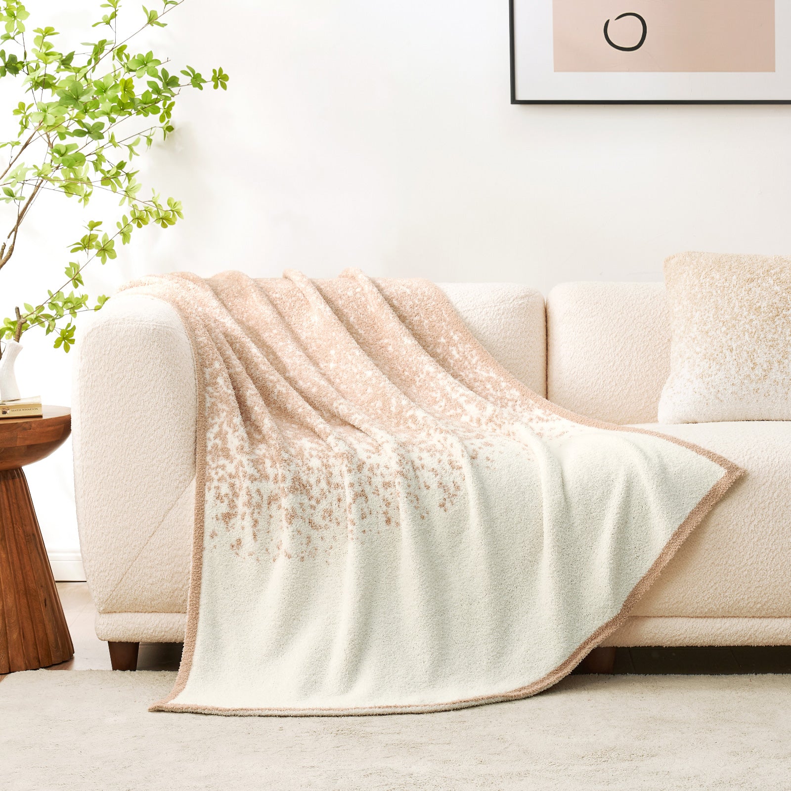Snuggle Sacs Reversible Ombre Heather Feather Yarn Knit Throw Blanket on a beige couch in a bright room#color_Khaki