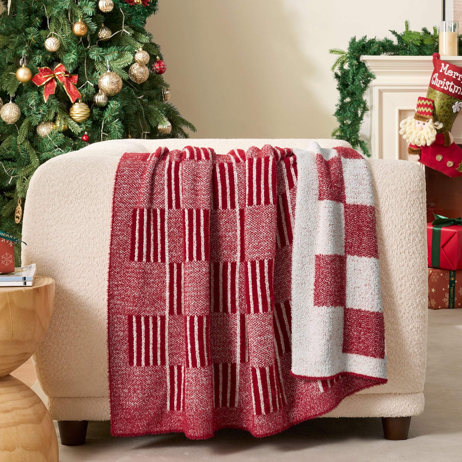 Red and white checkered blanket draped over a chair with a Christmas tree in the background. #color_Heather Red