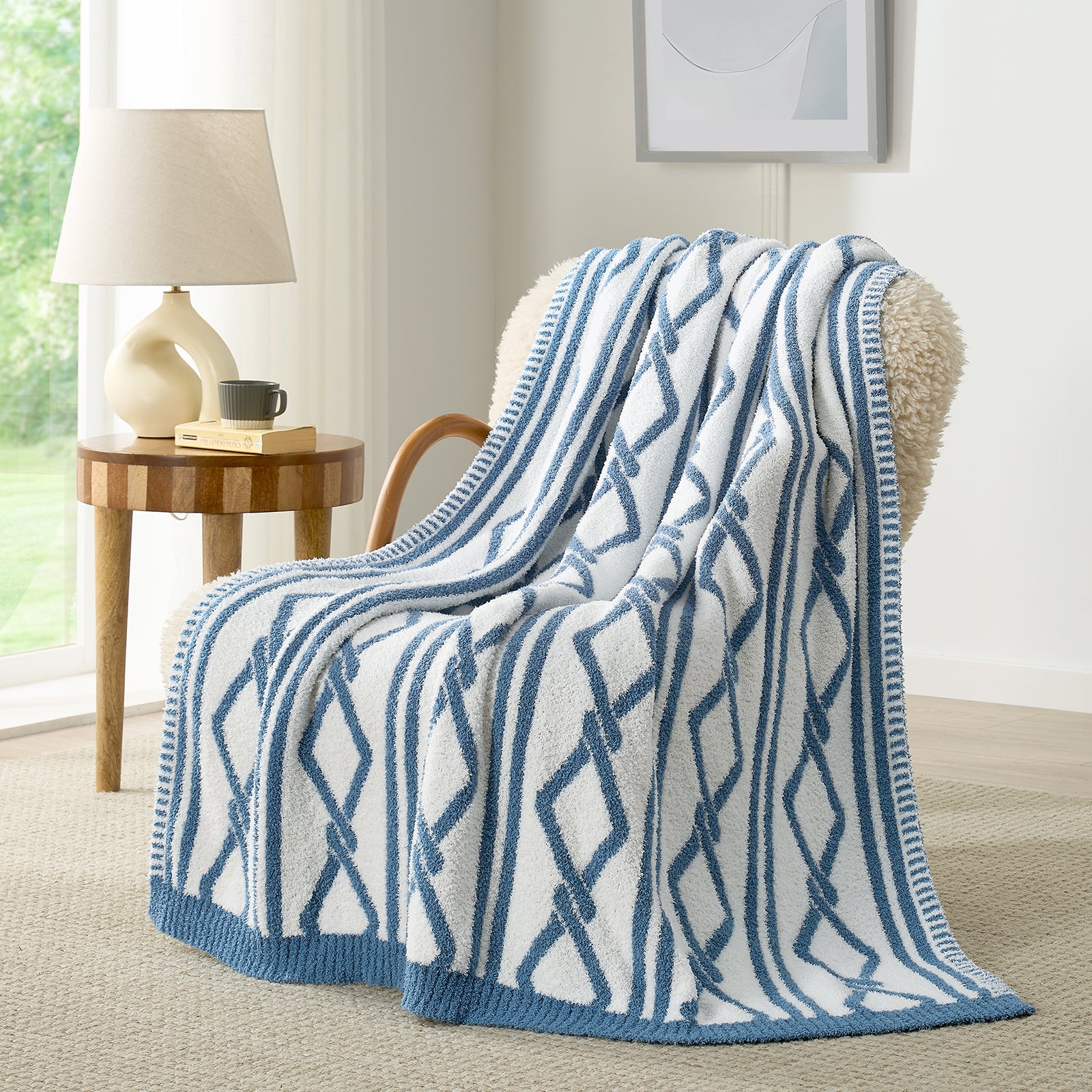 Snuggle Sacs Aesthetic Boho Feather Yarn Knit Throw Blanket on the chair with lamp and window behind#color_Blue