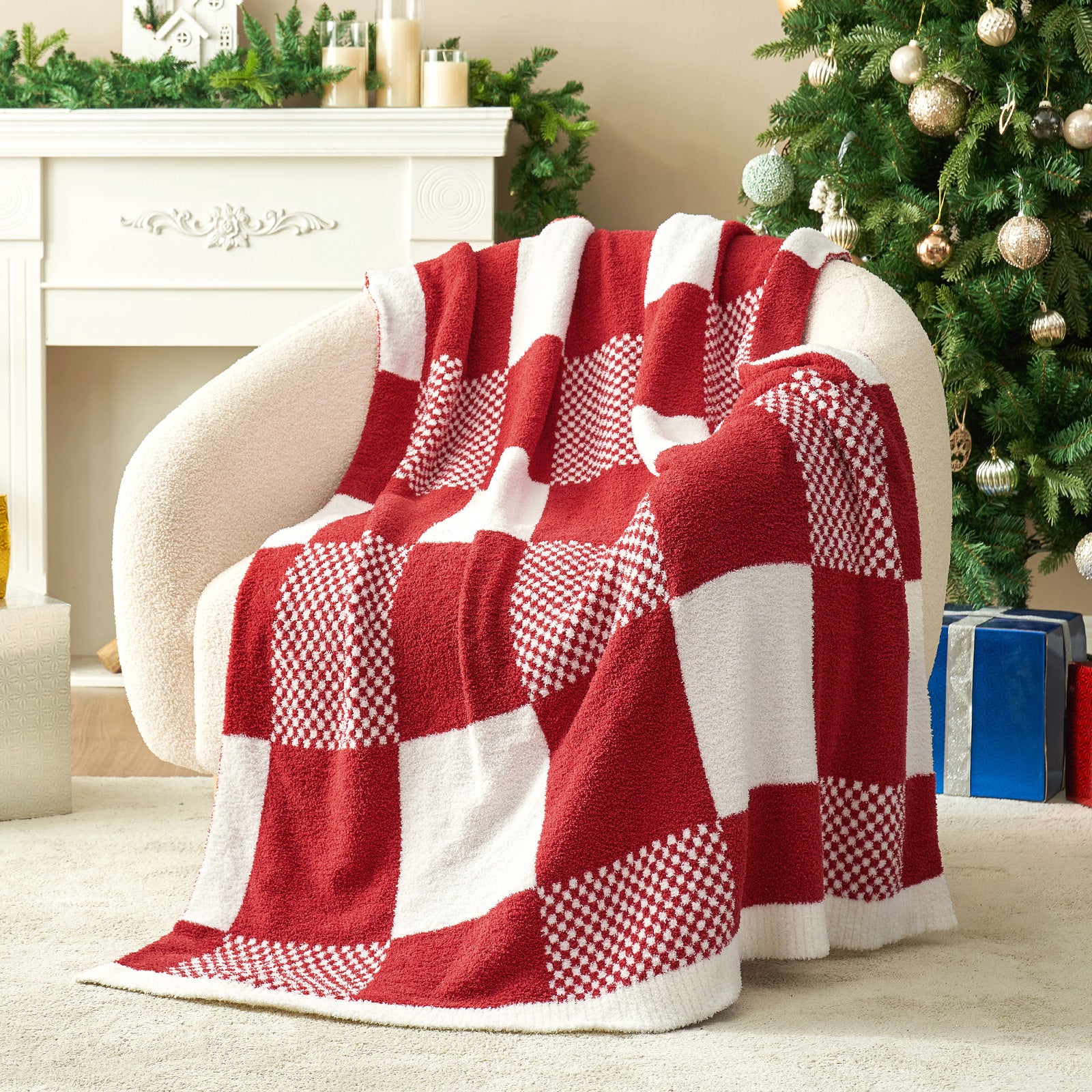 Red and white checkered blanket draped over a chair in a festive living room with a Christmas tree. #color_Red White