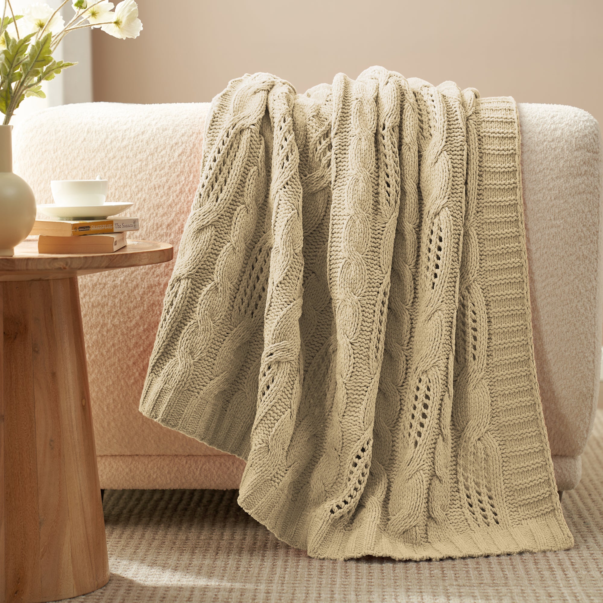 Cable chenille knit throw blanket in Beige draped over sofa creating an elegant home decor #color_Beige