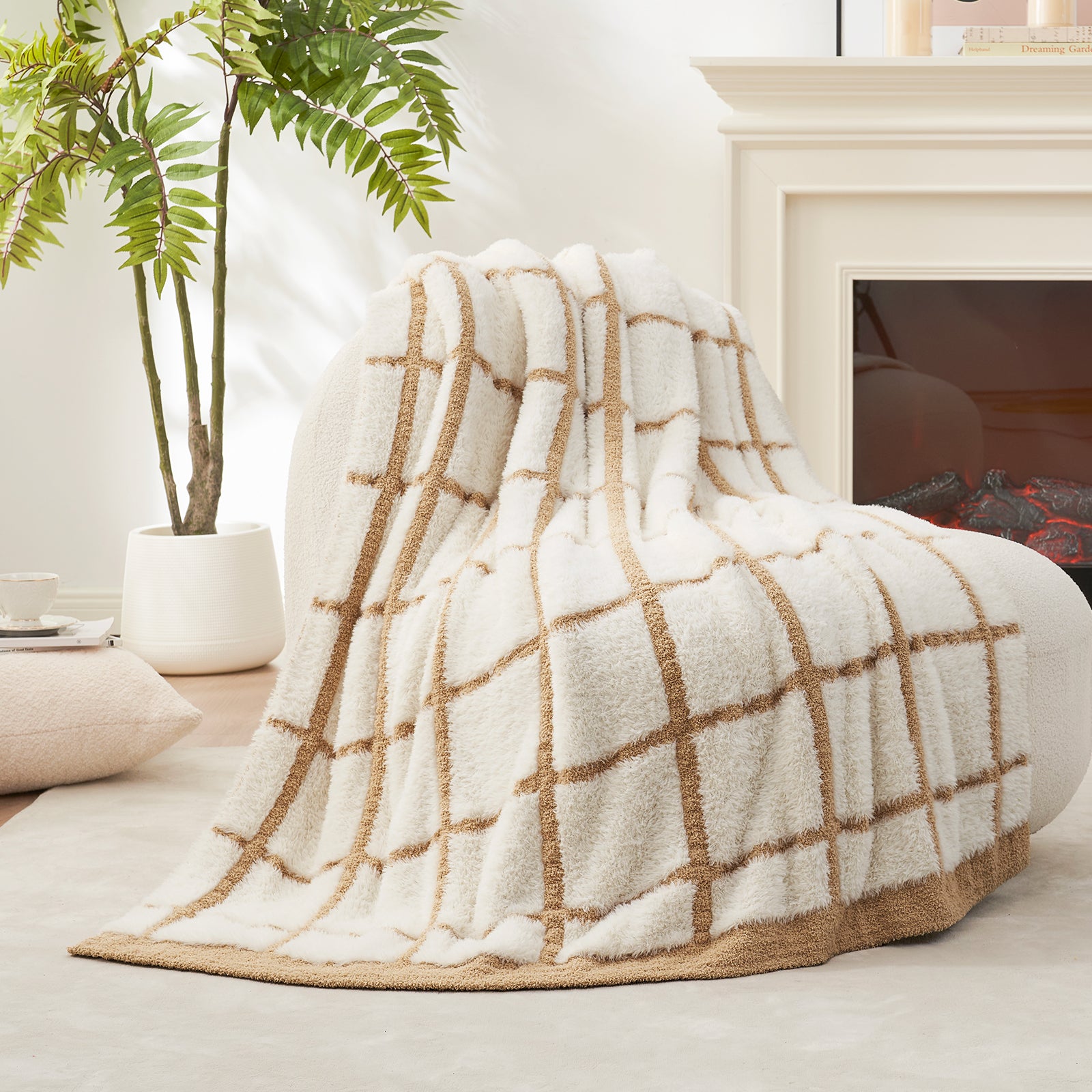 Beige and White blanket draped over a chair in a cozy living room.#color_Beige