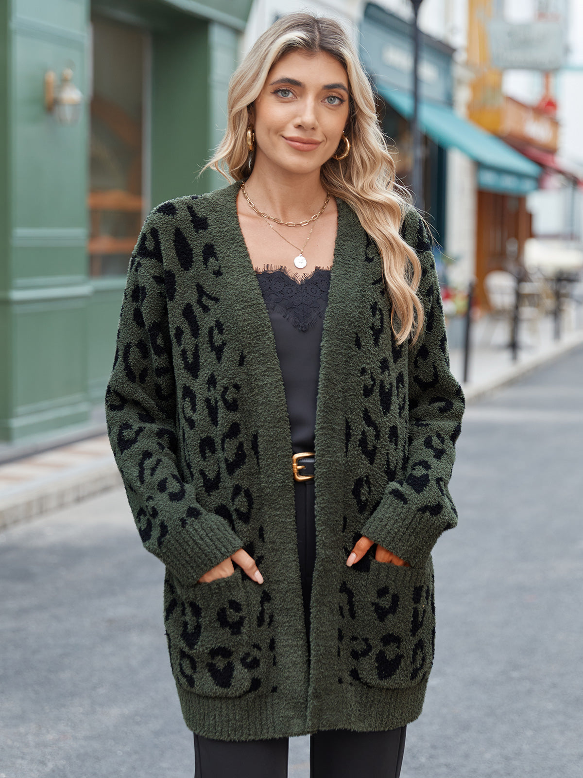 Woman wearing a green cardigan with a leopard print pattern on a city street. #color_Leopard Army Green