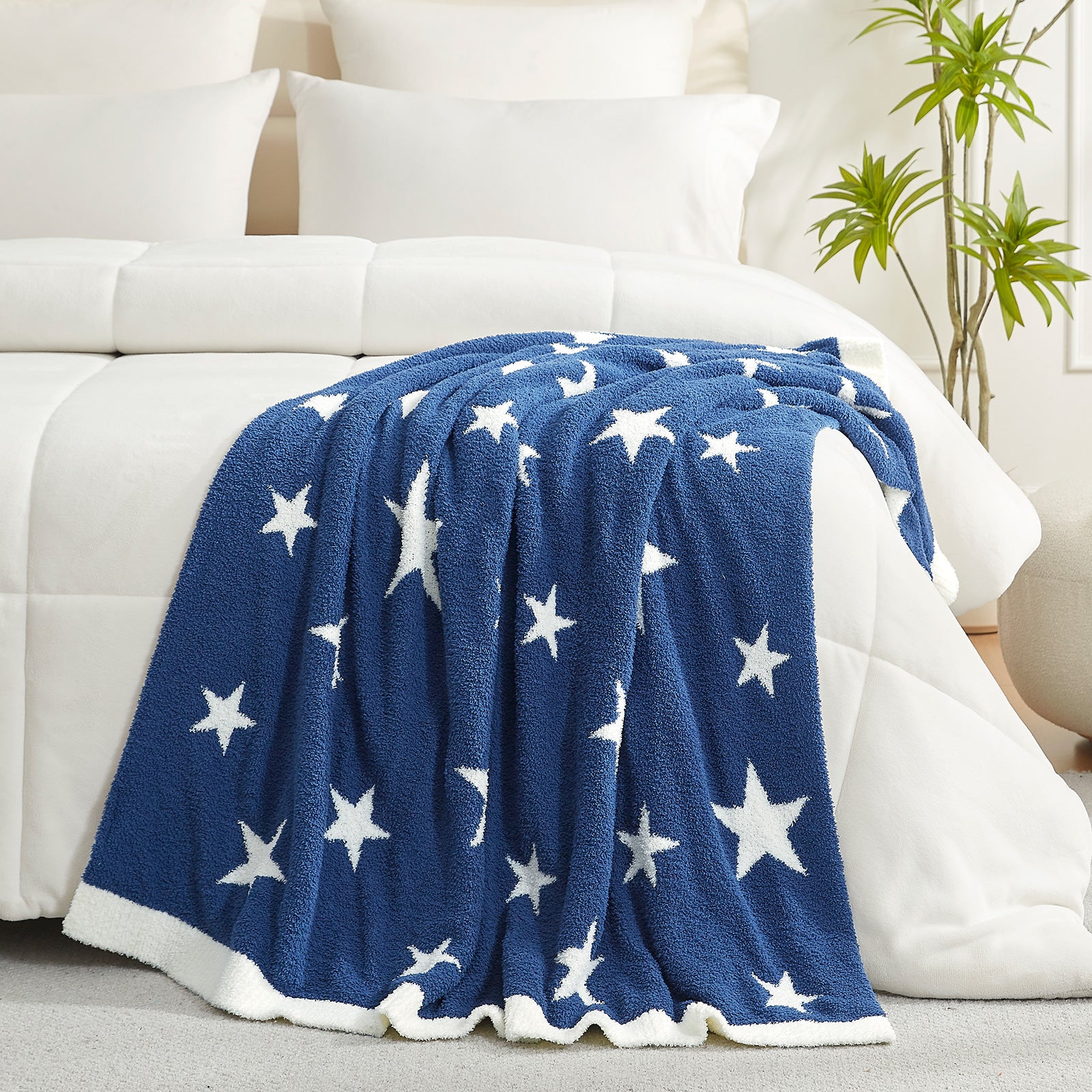 Snuggle Sacs Reversible Star Feather Yarn Knit Throw Blanket on a bed with plants in the room#color_Royal_Heather_Blue