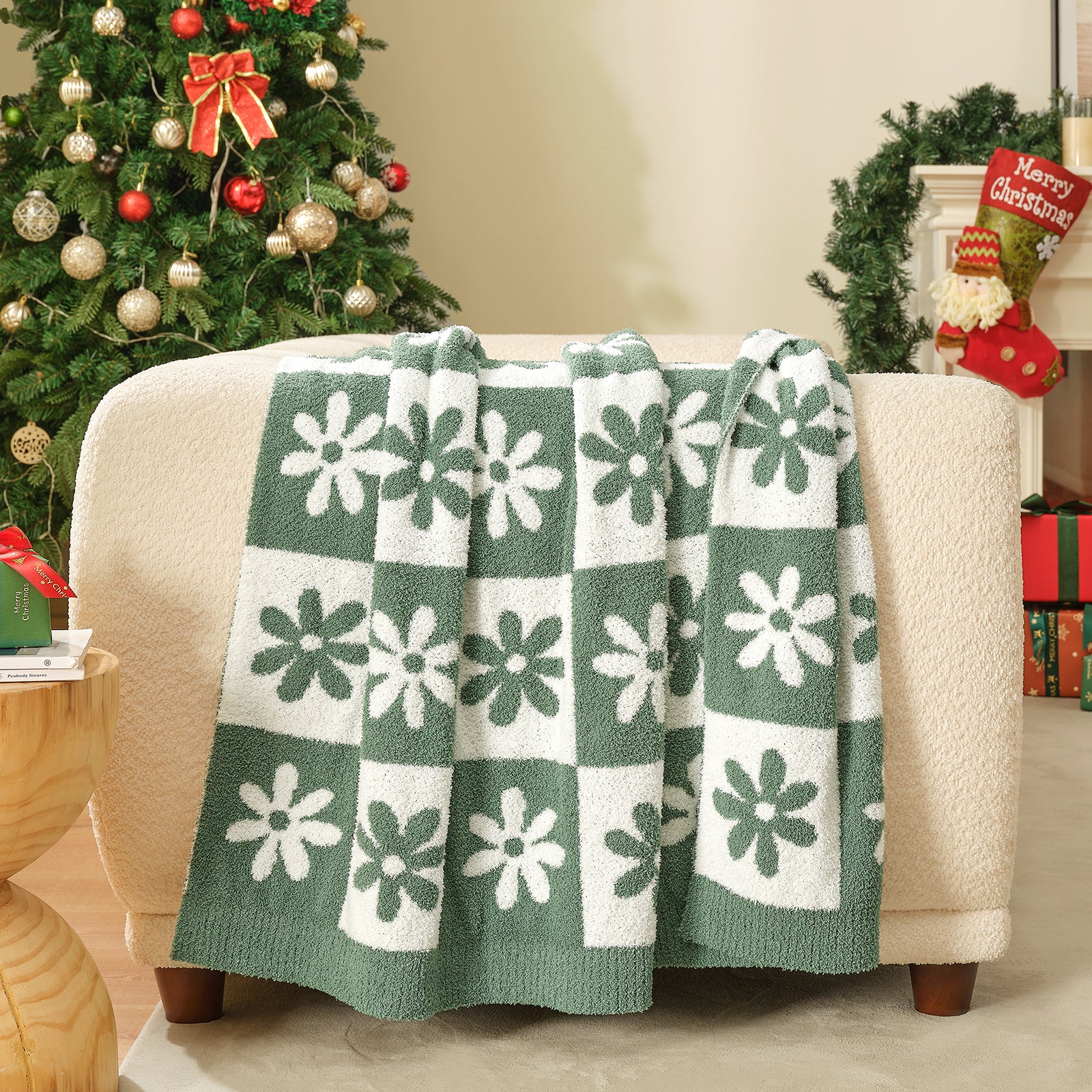 Green and white checkered blanket draped over a couch with a decorated Christmas tree in the background. #color_Xmas Green