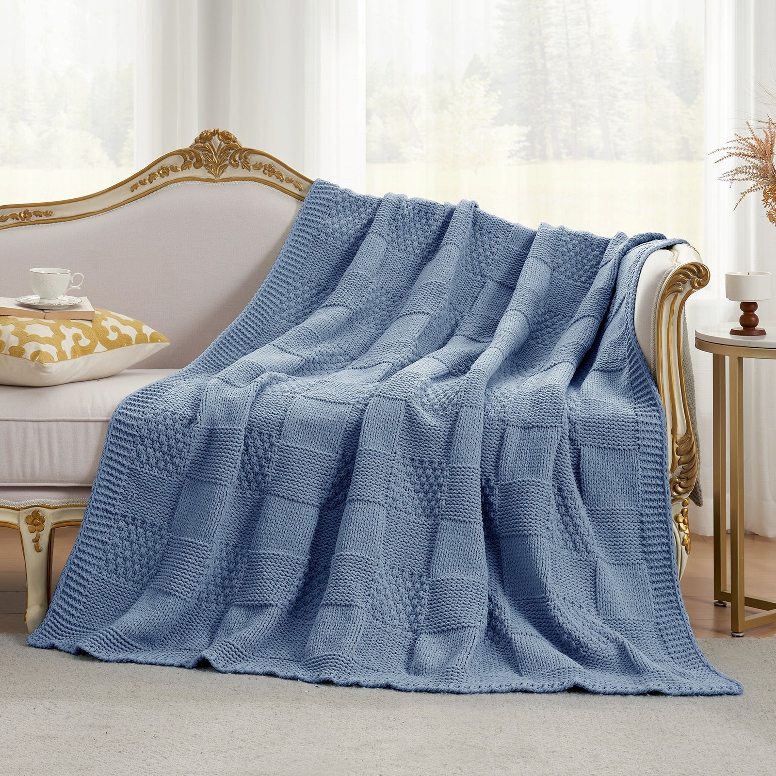 Two tone checkered chenille knit throw blanket in Washing Blue draped over a sofa creating a cozy and elegant living space #color_Washing Blue