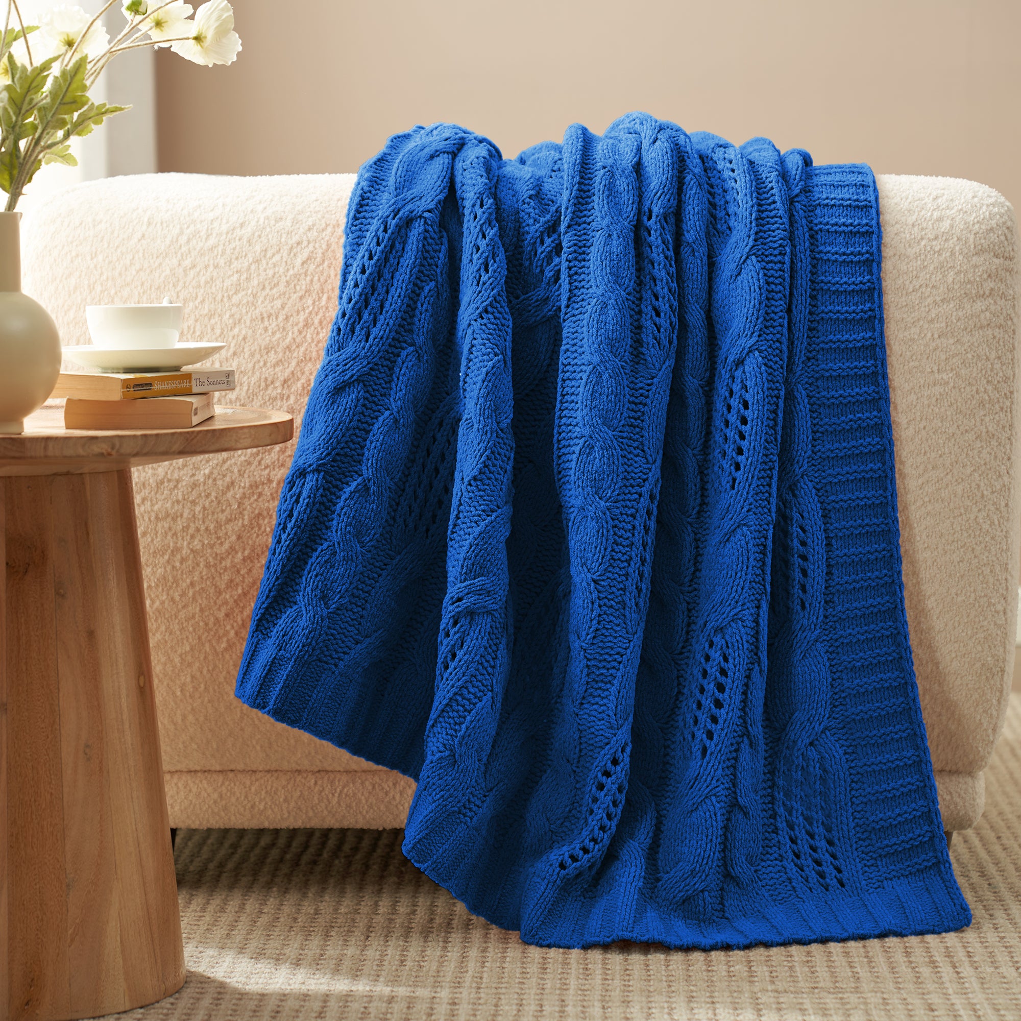 Cable chenille knit throw blanket in Navy Blue draped over sofa creating an elegant home decor #color_Navy Blue