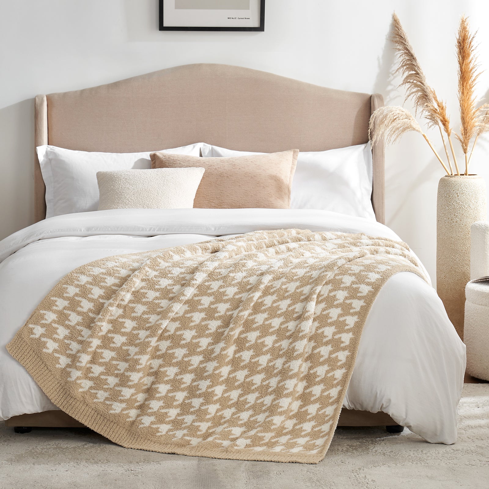 Beige patterned throw blanket on a bed with white bedding and pillows in a bedroom setting.#color_Beige
