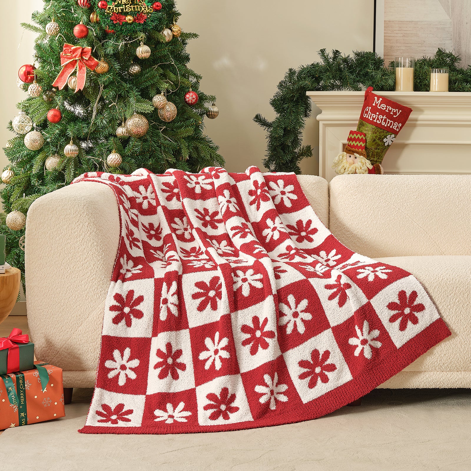 Red and white checkered blanket draped over a couch with a Christmas tree and decorations in the background. #color_Xmas Red