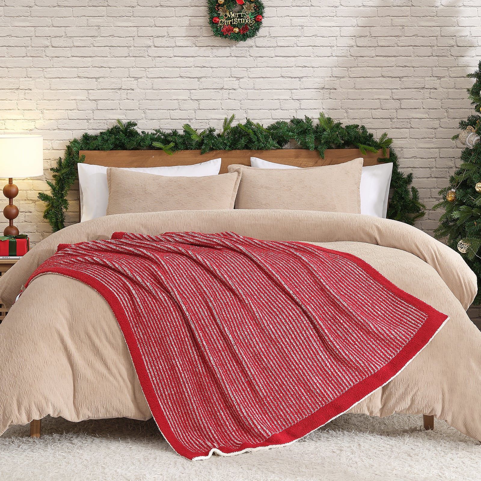 Beige bedding with a red blanket on a bed decorated for Christmas. #color_Red/Cream