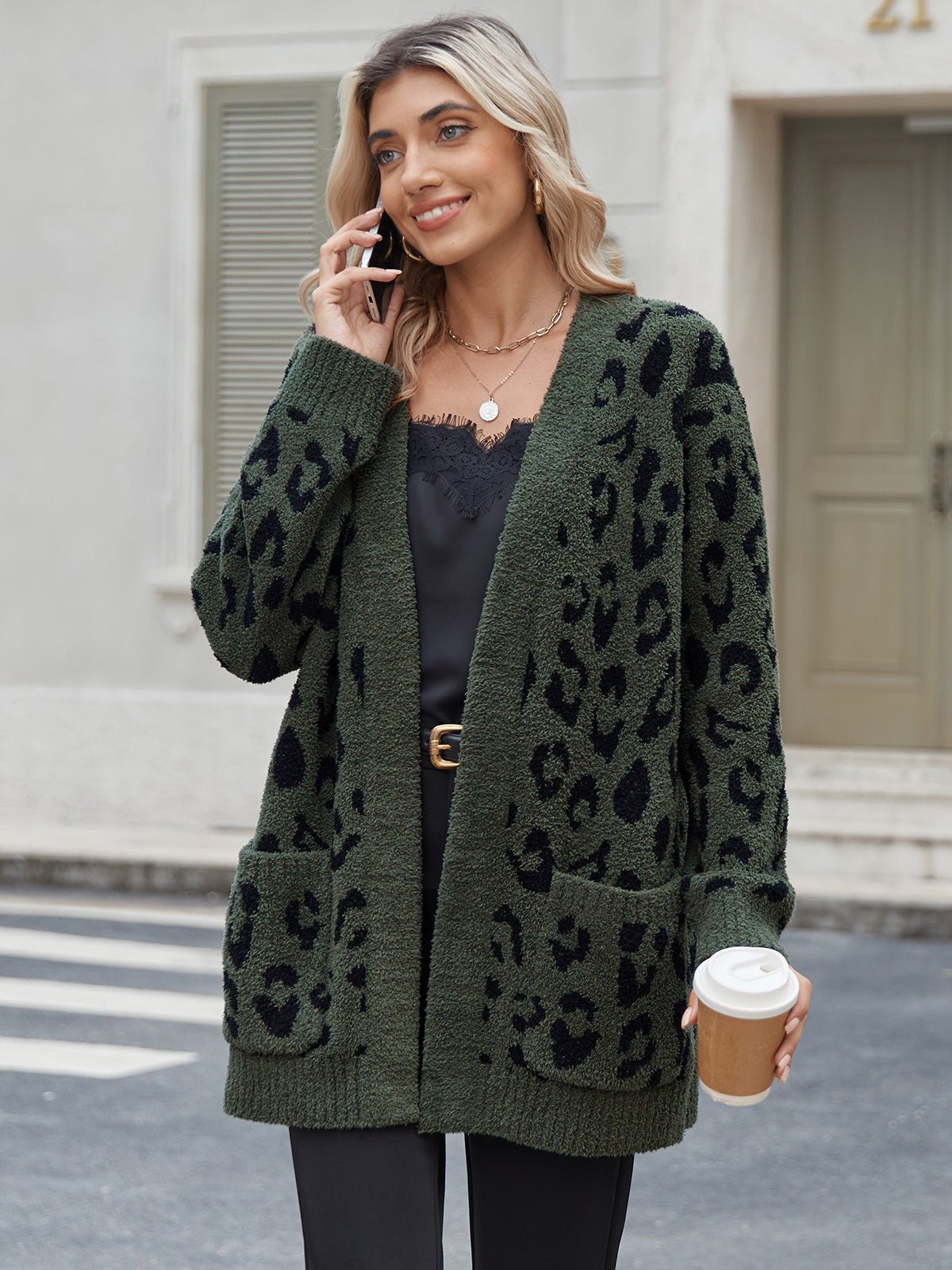 Woman wearing a green cardigan with black leopard print, talking on a phone and holding a coffee cup. #color_Leopard Army Green