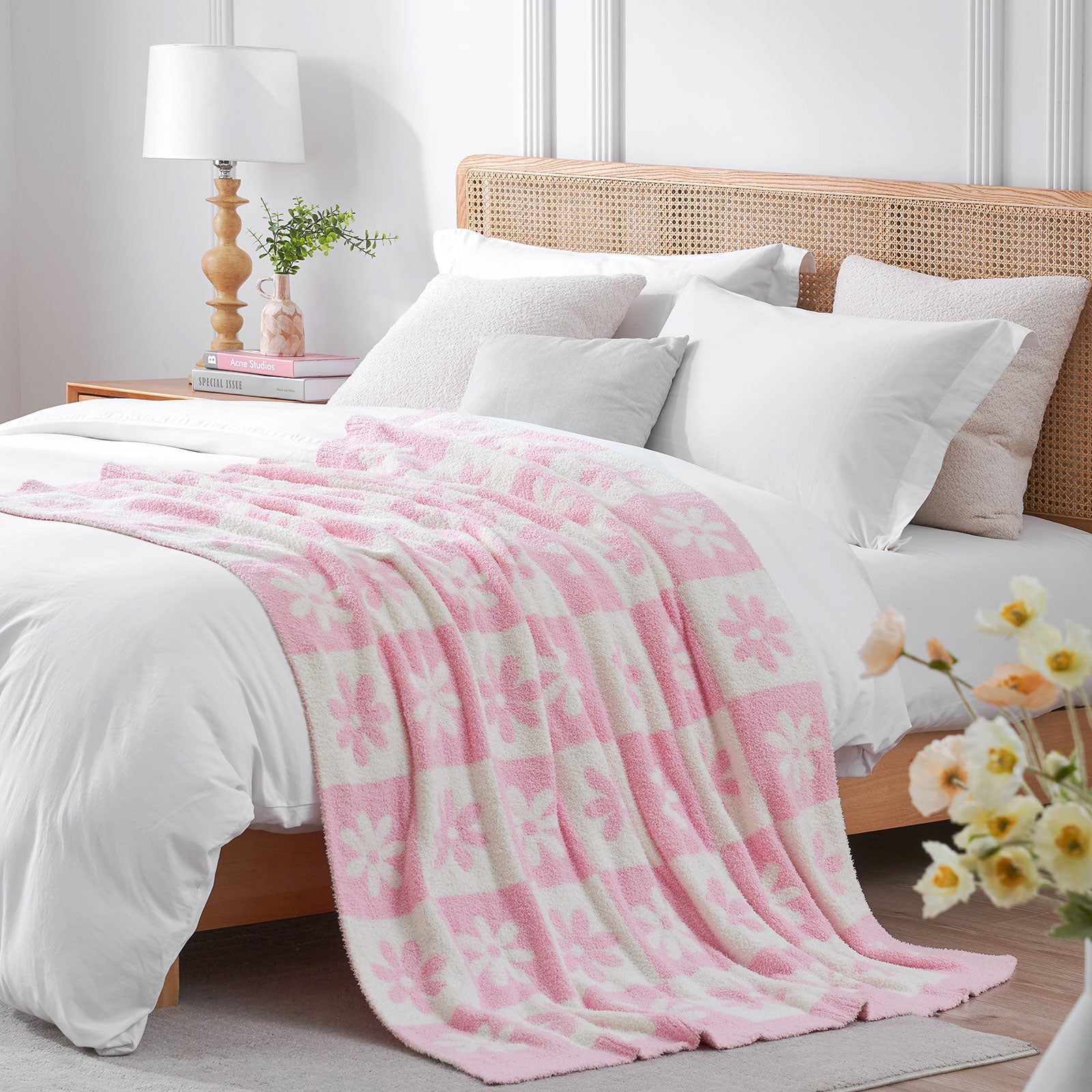 Bed with pink and white checkered blanket, white pillows, and a wooden headboard. #color_Baby Pink