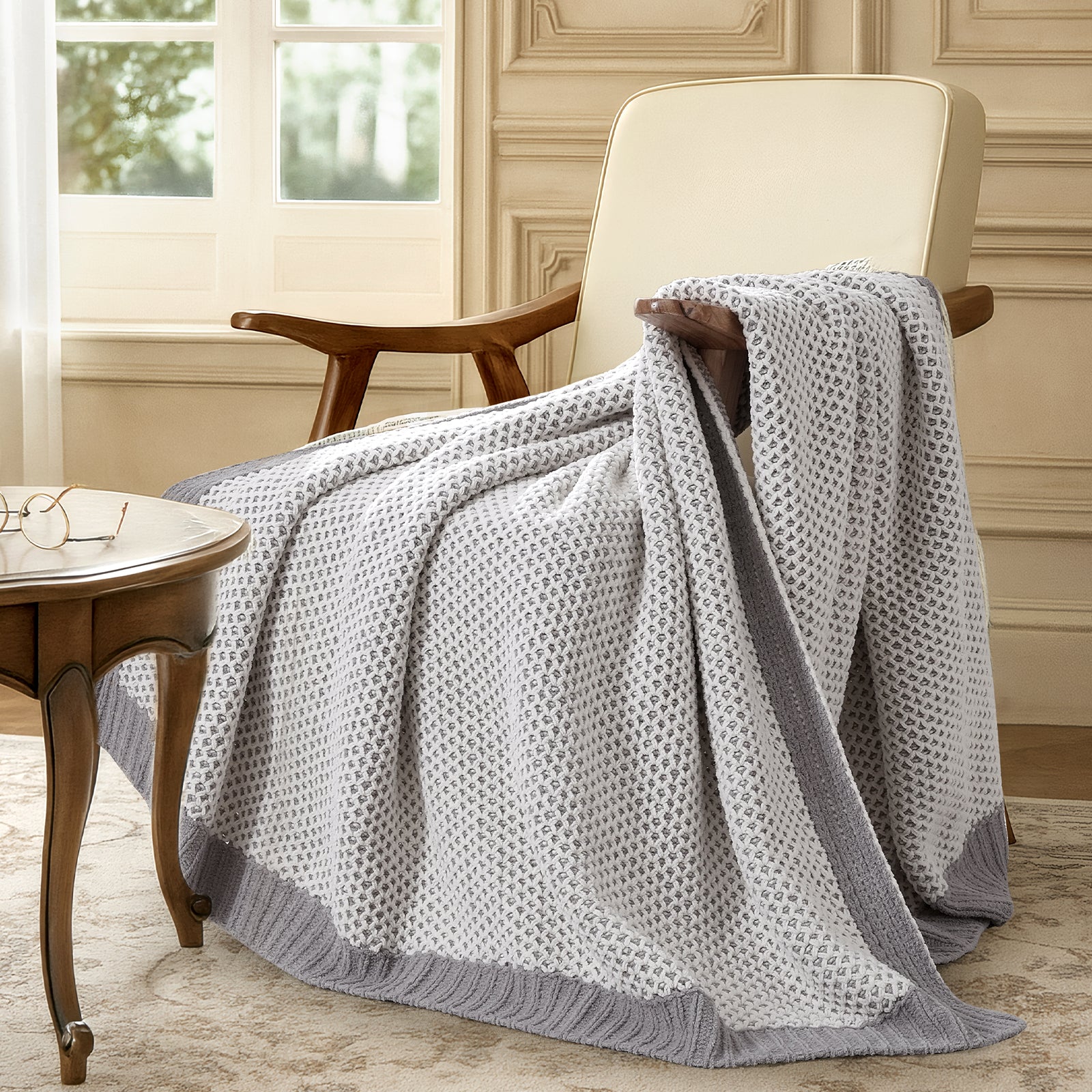 Snuggle Sac two tone chenille knit throw blanket in Grey draped over a chair creating a relaxed and cozy corner #color_Grey