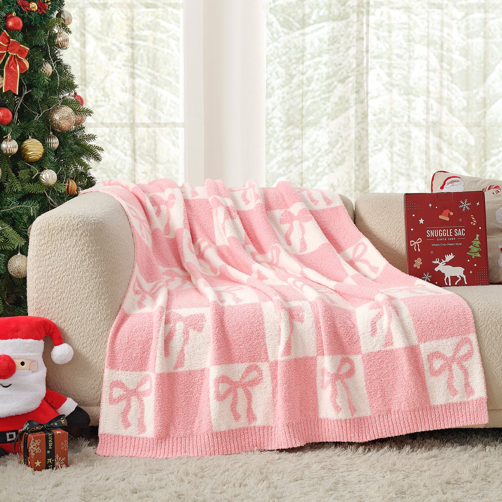 Pink and white checkered blanket with bows draped over a couch next to a Christmas tree. #color_Pink Bow