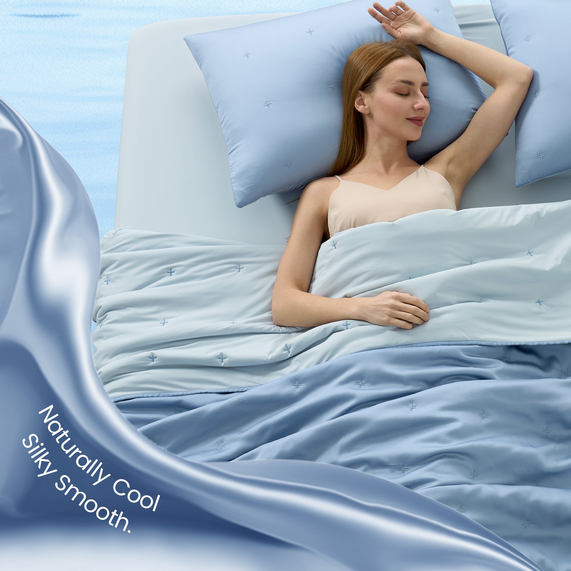 A woman laying down on the bed with Snuggle Sac Cooling comforter showing naturally cool and silky smooth#color_Blue
