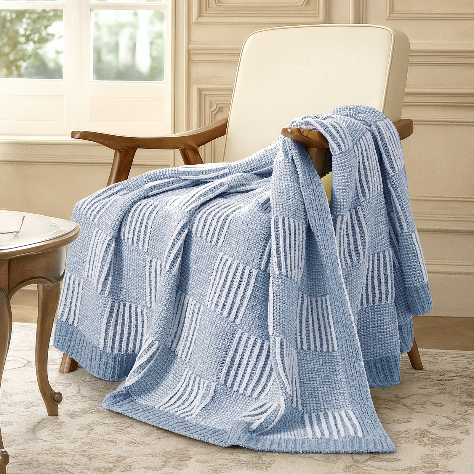 Blue patterned throw blanket draped over a chair in a home setting. #color_Blue