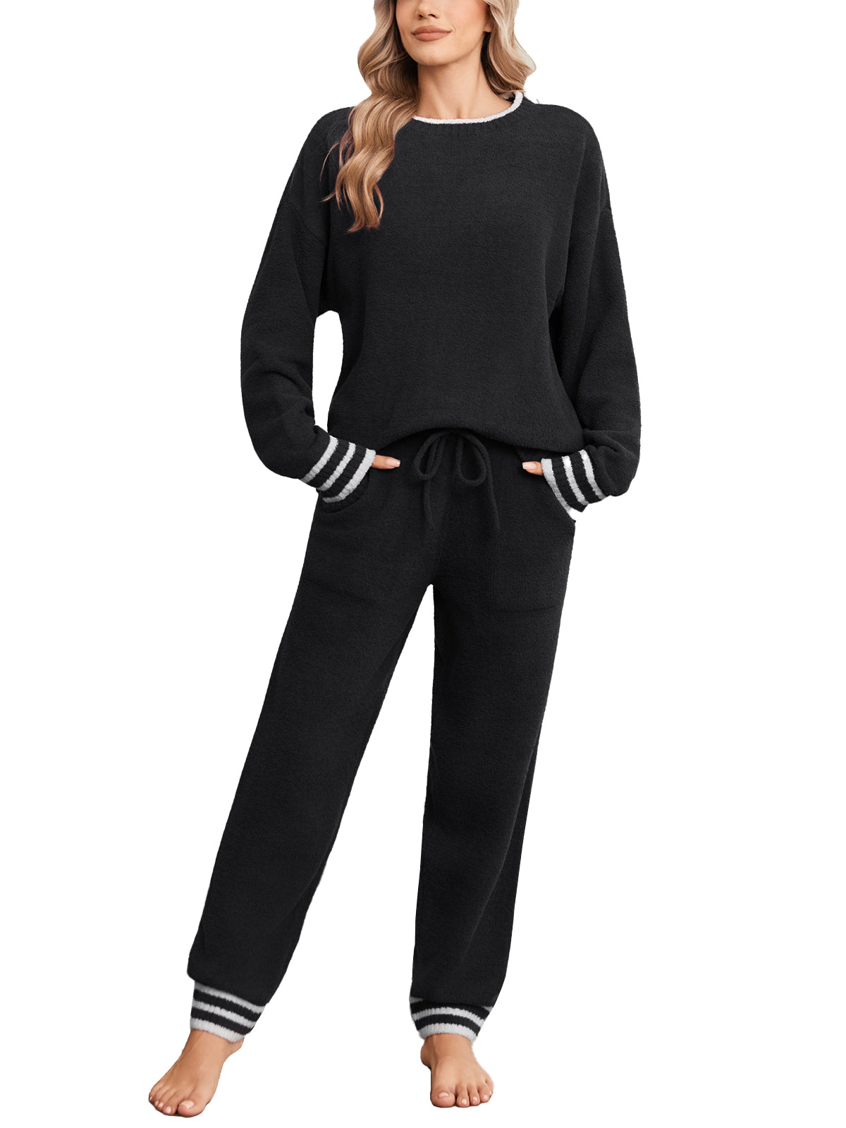 Black pajama set with striped cuffs worn by a model on a white background #color_Black