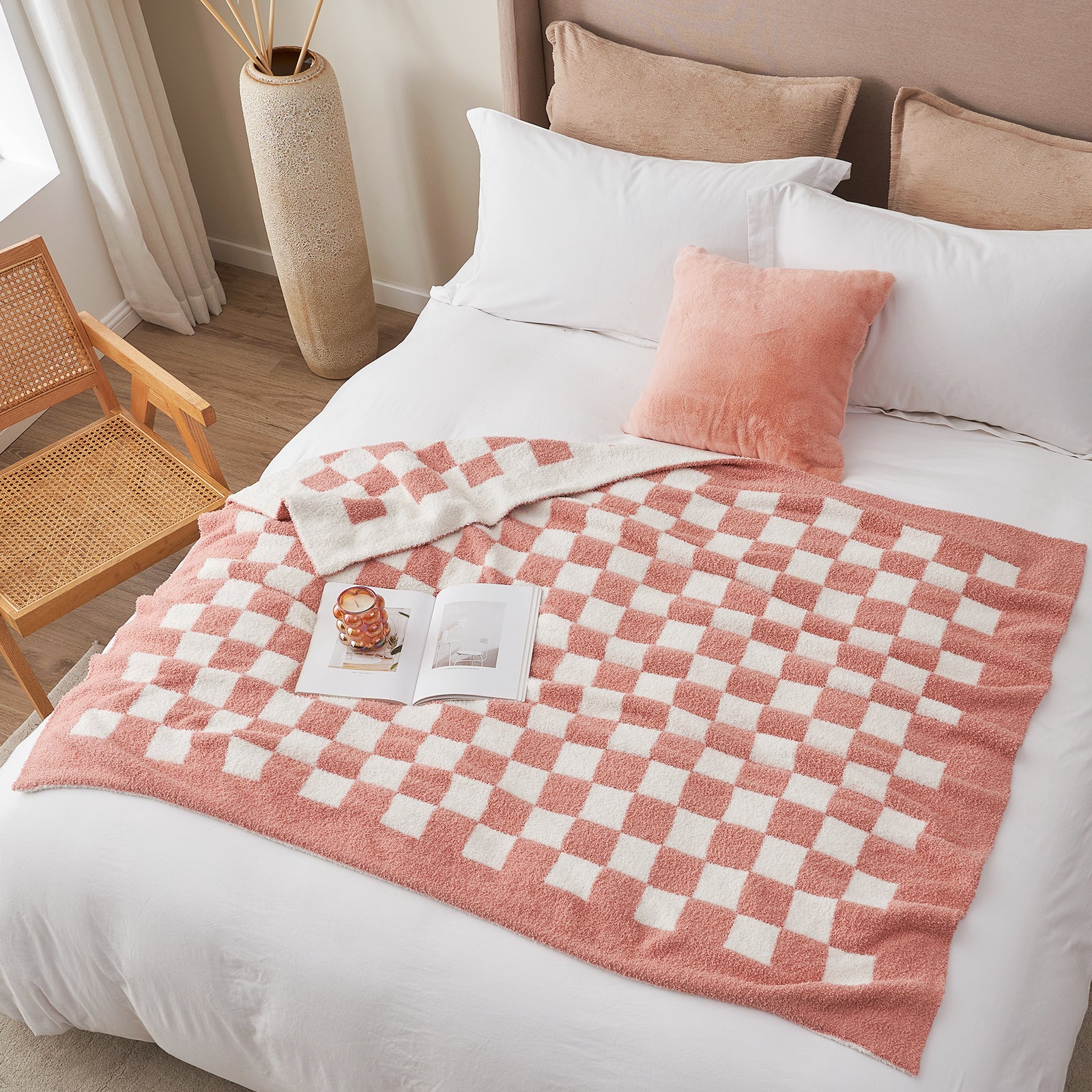 Bed with pink and white checkered blanket and pink pillow in a bedroom setting. #color_Checkered Pink