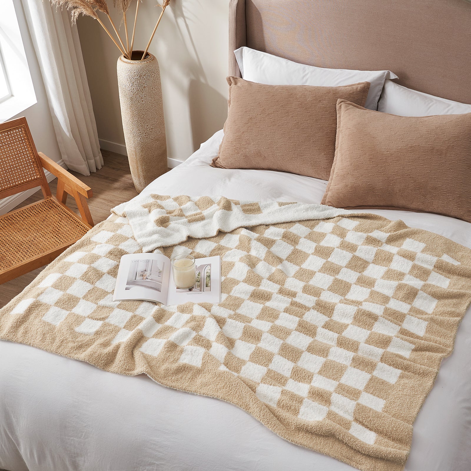 Bed with beige and white checkered blanket, brown pillows, and a small wooden chair in a bright room. #color_Checkered Beige
