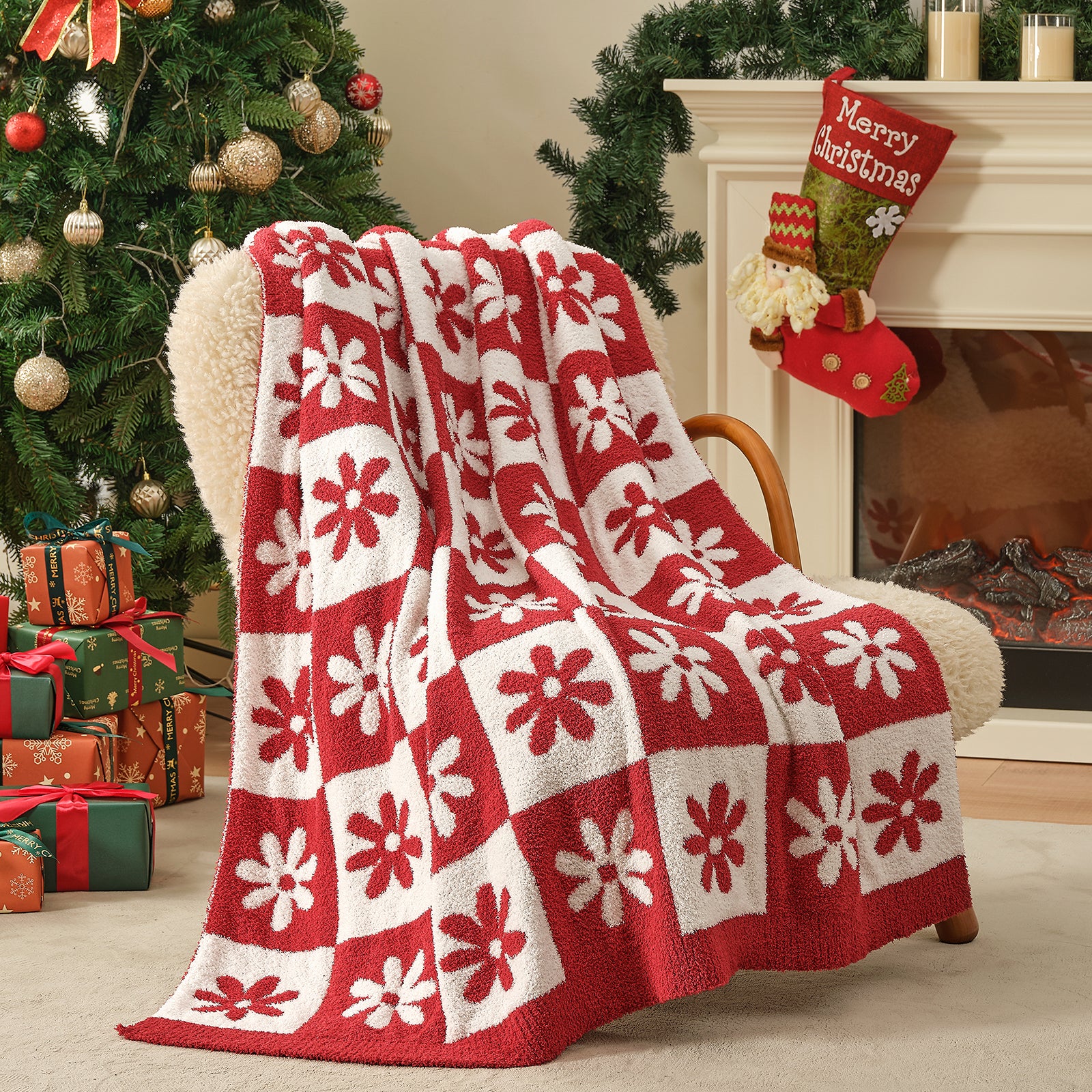 Red and white patterned blanket draped over a chair in a festive living room with Christmas decorations. #color_Xmas Red