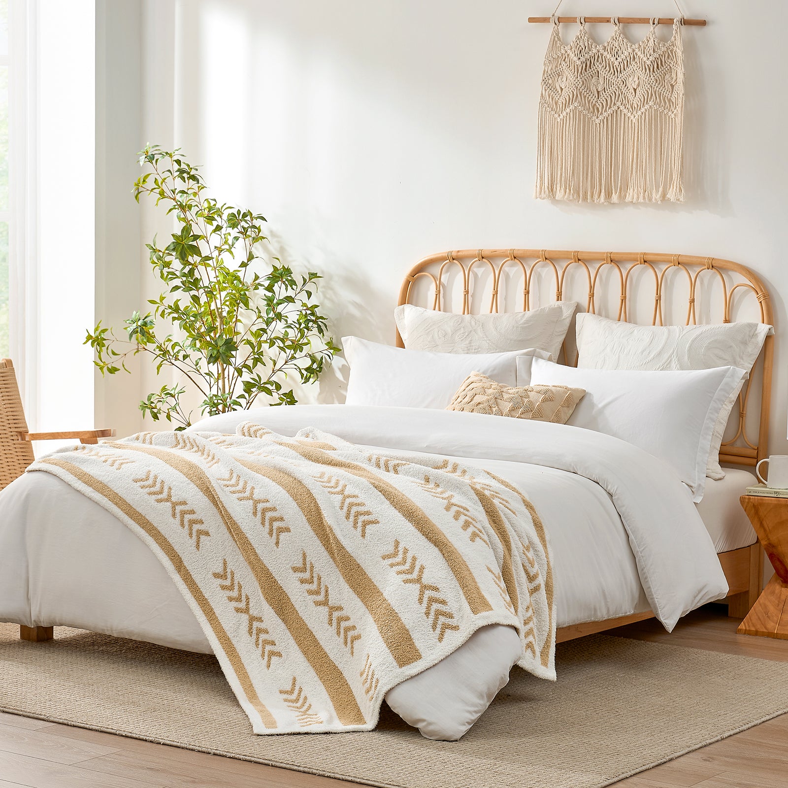 Snuggle Sacs Reversible Boho Feather Yarn Knit Throw Blanket on the bed in a bright room with plant and furniture#color_beige