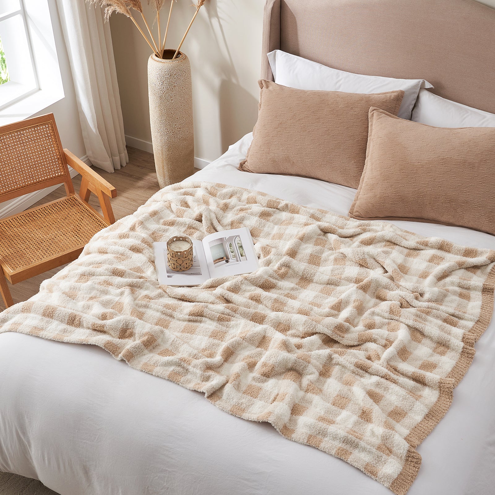 Beige checkered blanket on a bed with pillows and a chair in the background. #color_Plaid Beige