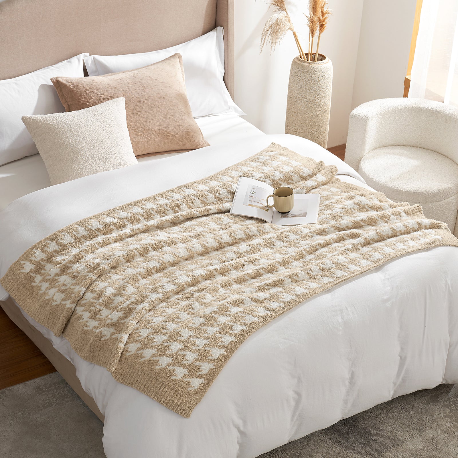 Beige patterned throw blanket on a bed with pillows and a cup in a cozy bedroom setting. #color_Beige
