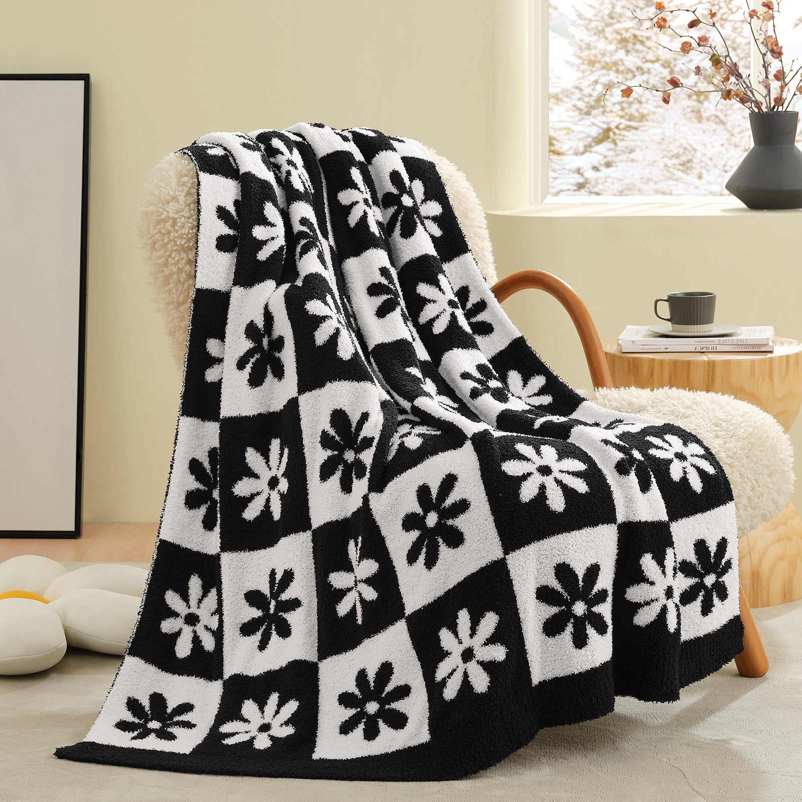 Black and white patterned blanket draped over a chair in a cozy living room. #color_Black