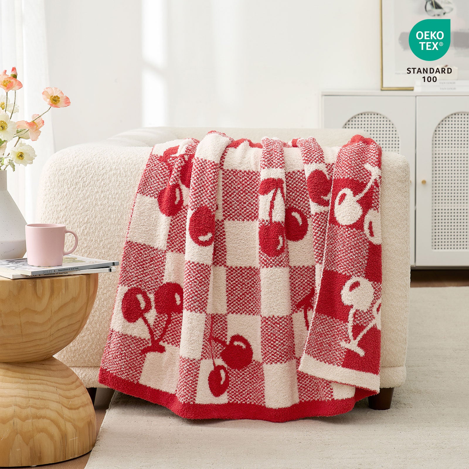 Snuggle Sacs Red Cherry Feather Yarn Knit Throw Blanket drapped on the beige couch in a bright room with OEKO-TEX certificate on top#color_Red_Cherry