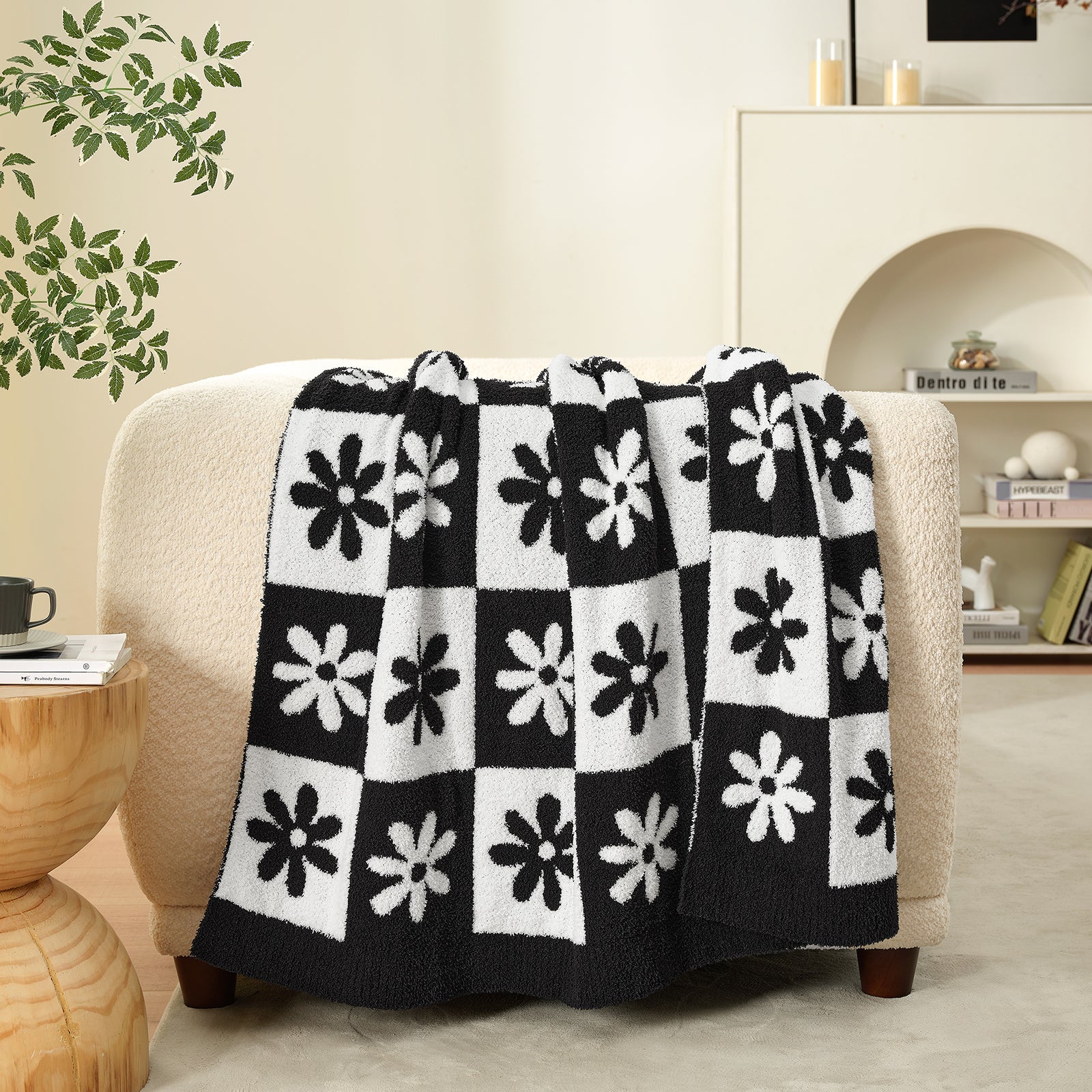 Black and white patterned blanket draped over a chair in a living room setting. #color_Black