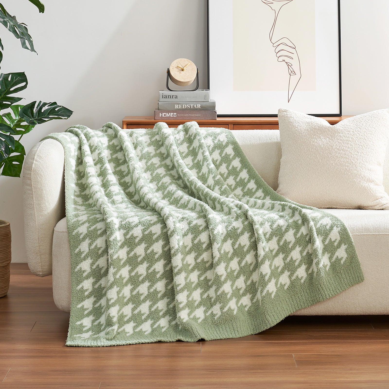 Green and white patterned blanket draped over a beige sofa in a living room. #color_Green