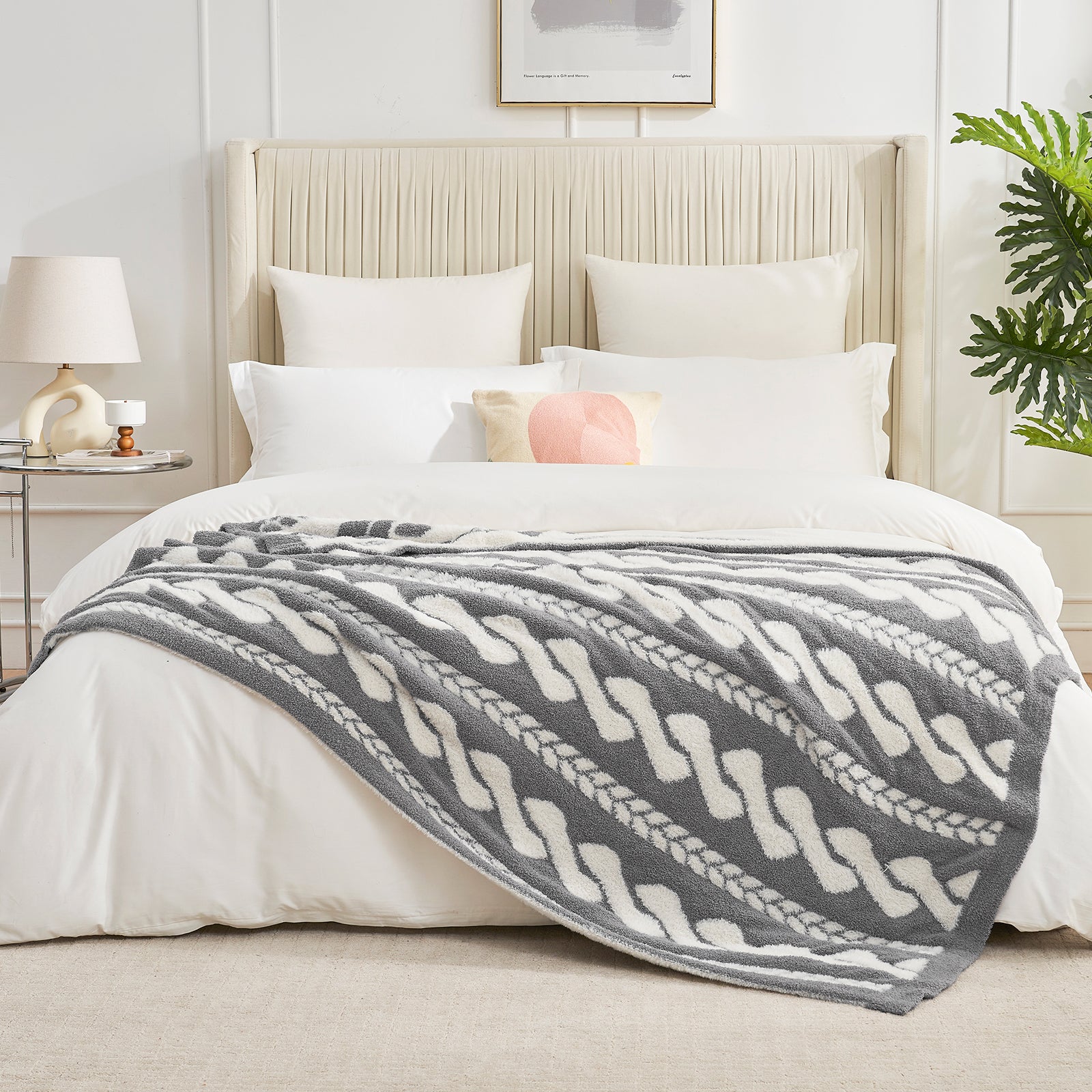 Cable pattern Faux Fur Knit Throw Blanket in gray and white on a bed in a bedroom setting.#color_Gray