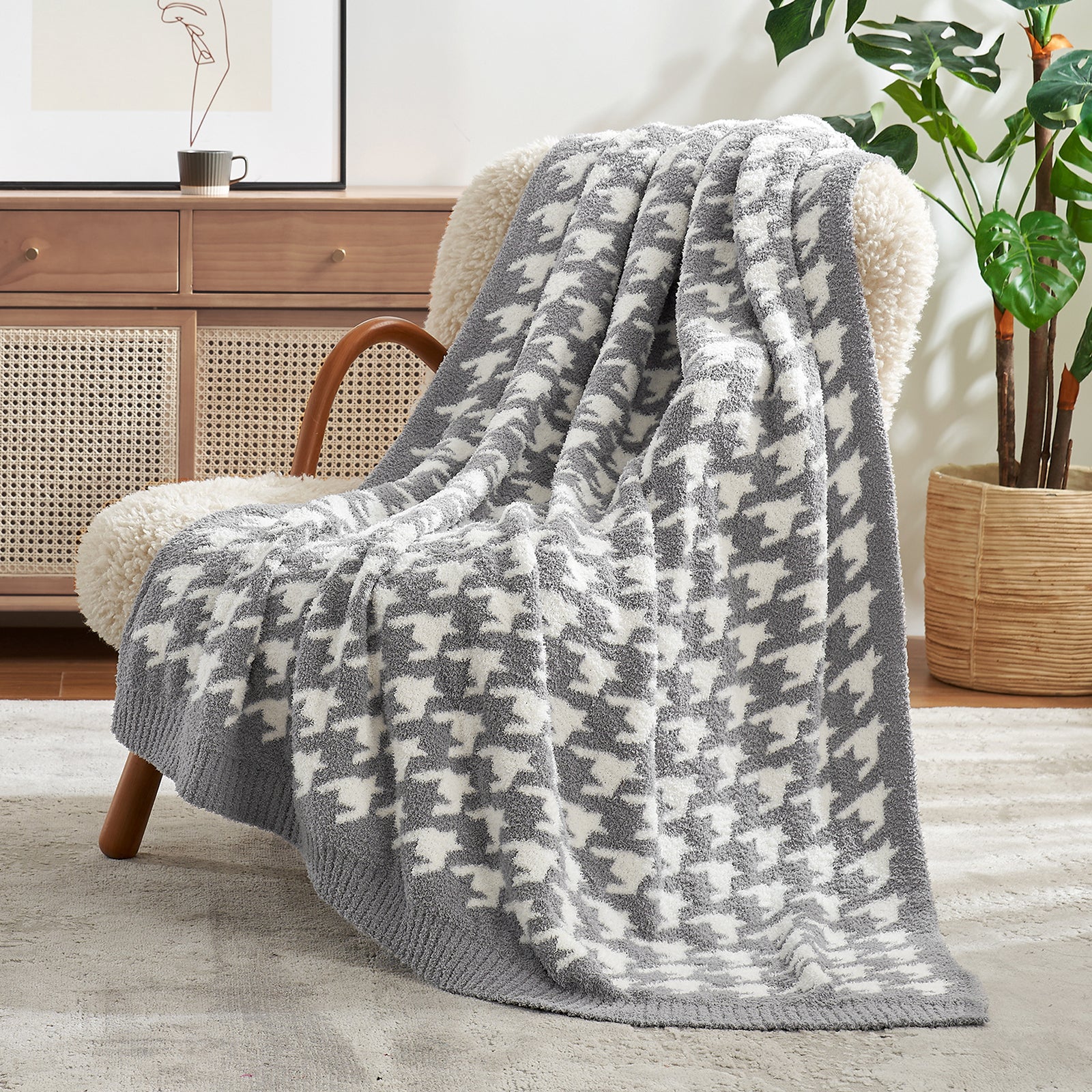 Gray and white patterned blanket draped over a chair in a cozy living room. #color_Grey