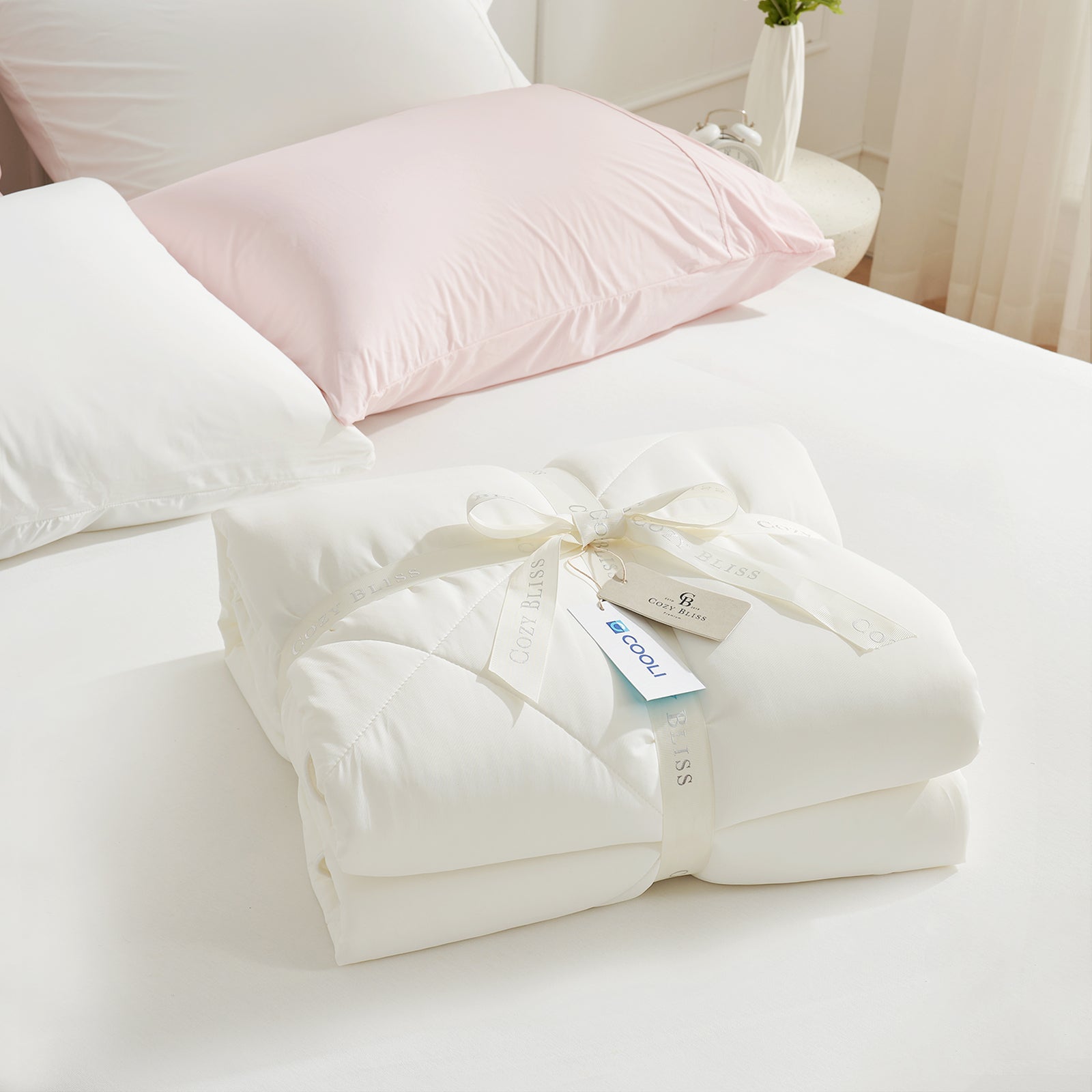 Folded white comforter with white ribbon,perfect as gift.#color_Cream White
