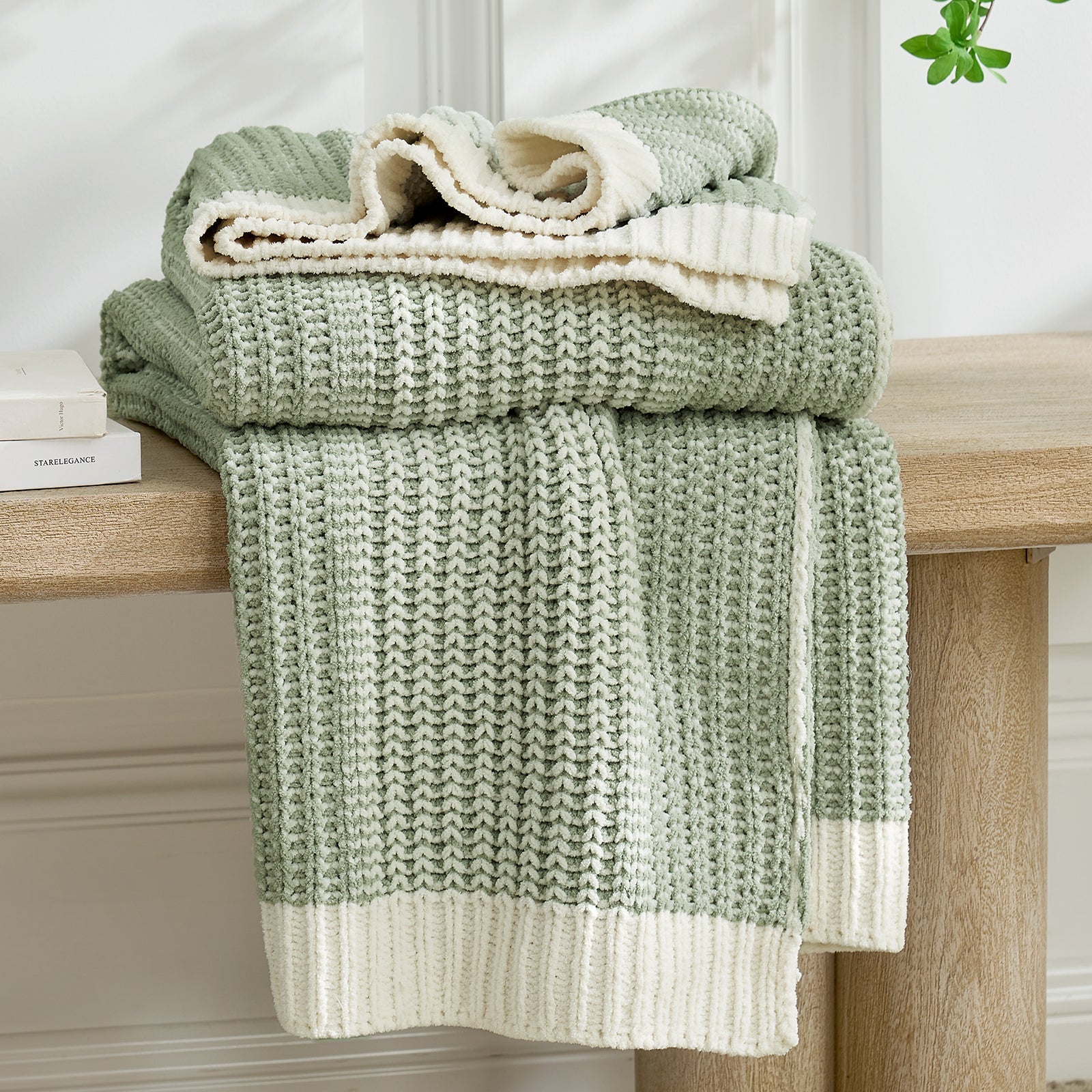 Stack of green and white textured towels on a wooden surface #color_Two-tone Green