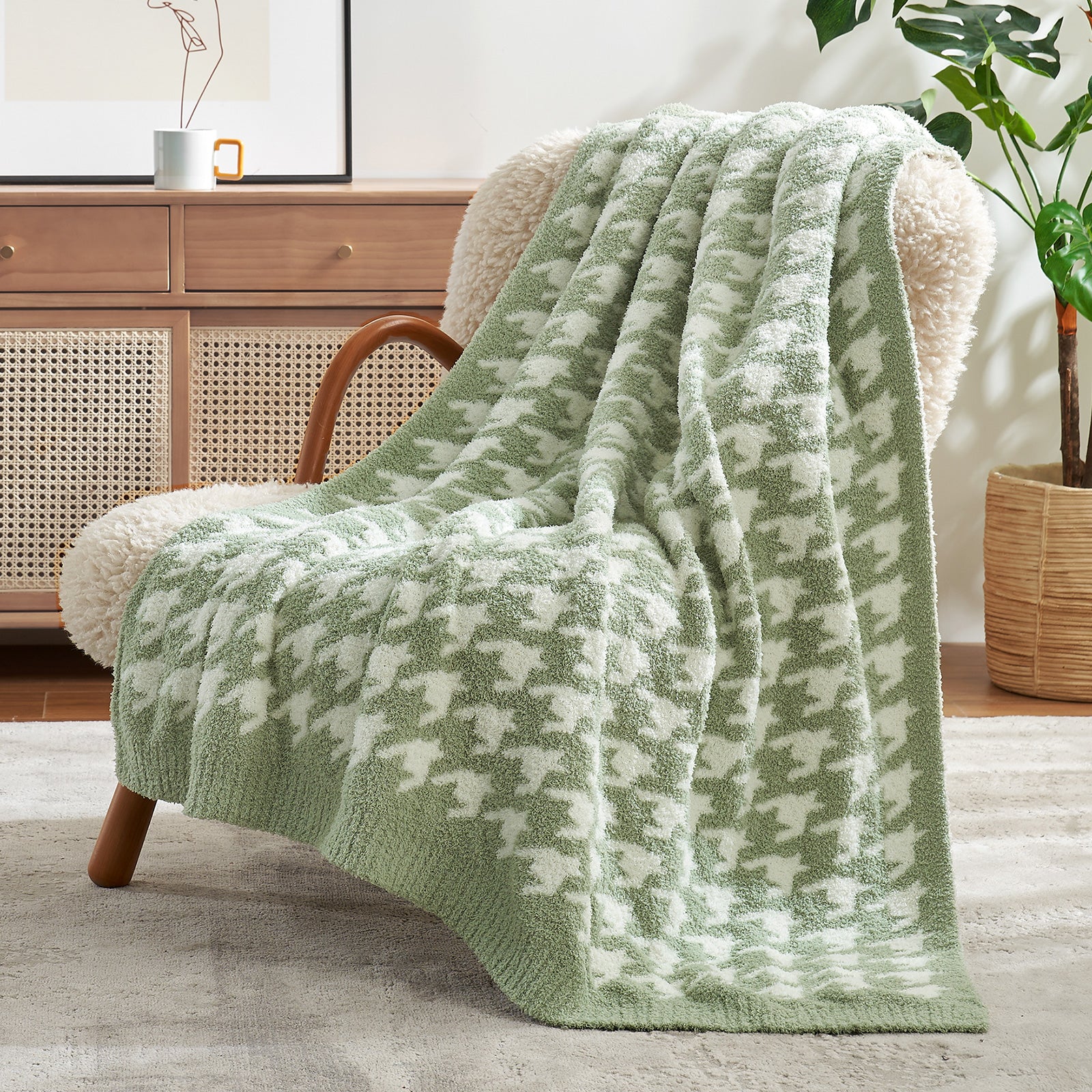 Green and white patterned blanket draped over a chair in a living room setting. #color_Green