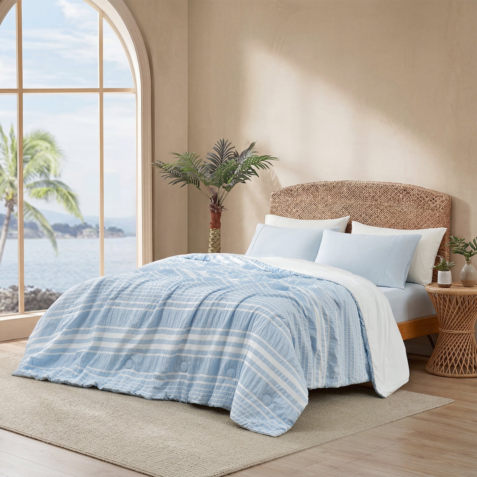 Snuggle Sac cationic dyed striped seersucker cooling comforter in Sky Blue layered on a bed #color_Sky Blue