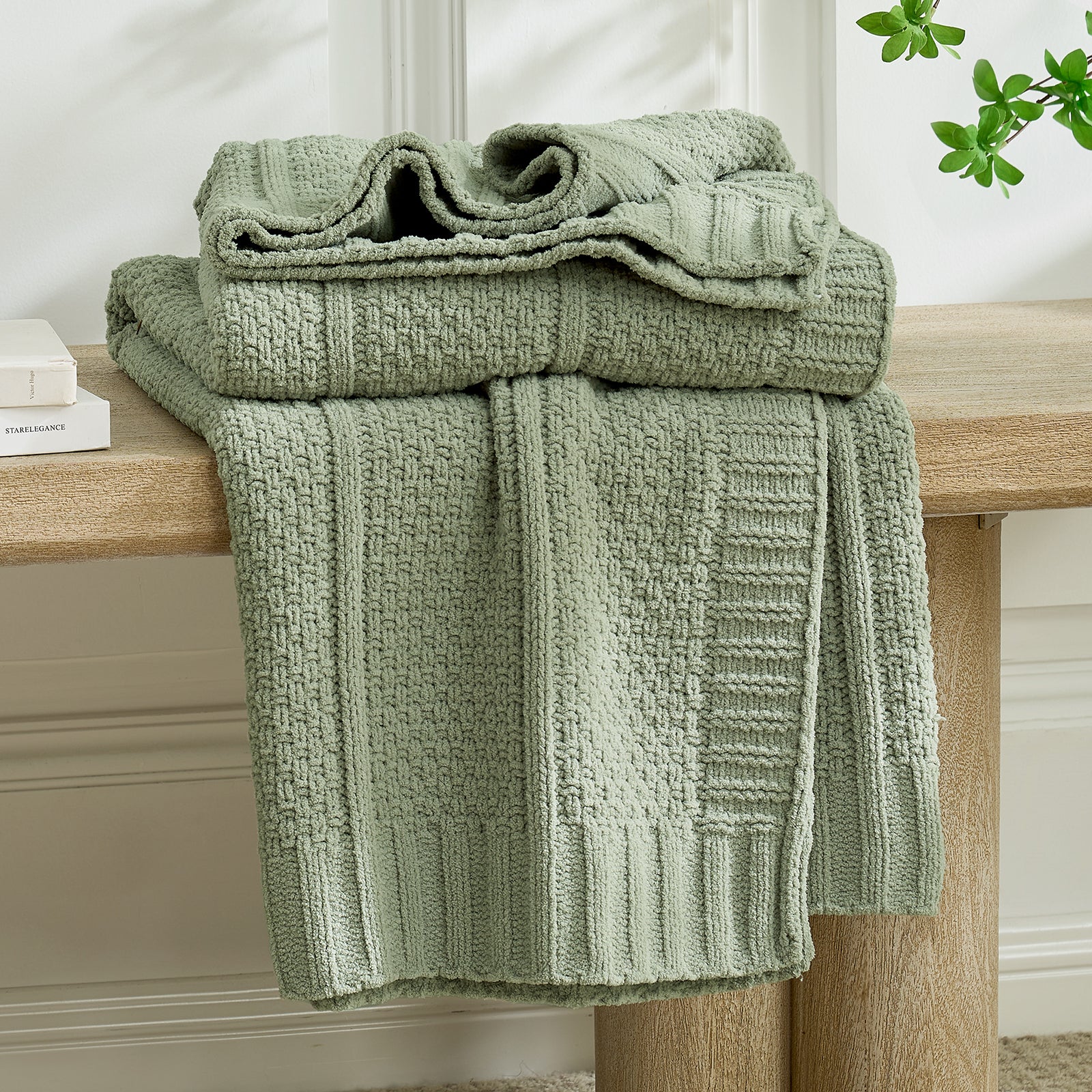 Stack of green textured towels on a wooden surface with a neutral background #color_Sage Green