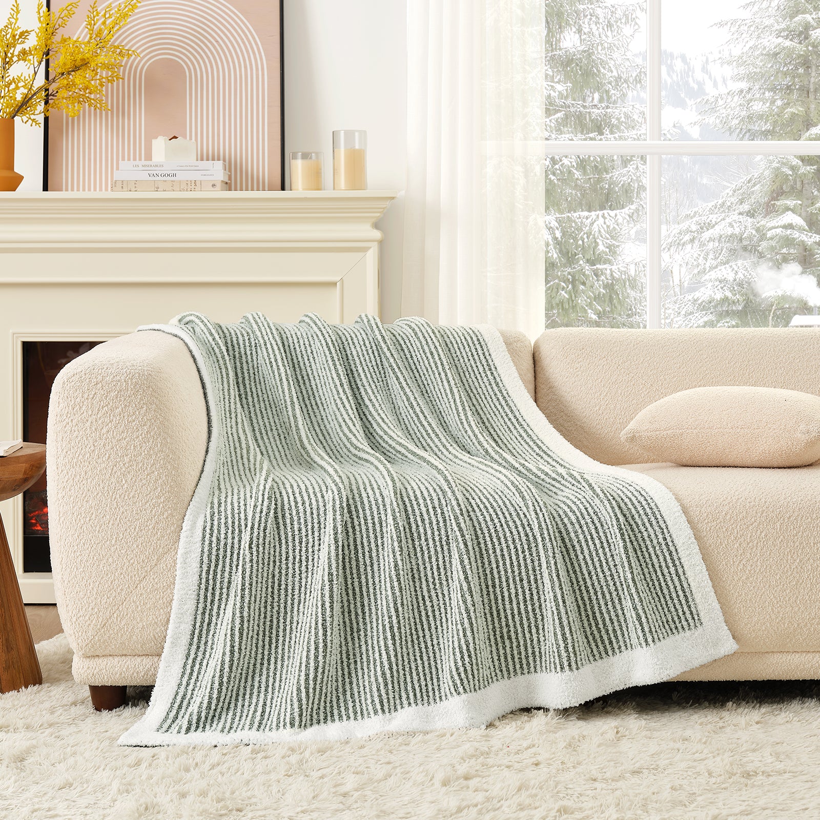 Green textured throw blanket on a beige sofa in a living room with a fireplace and window. #color_Green/Cream