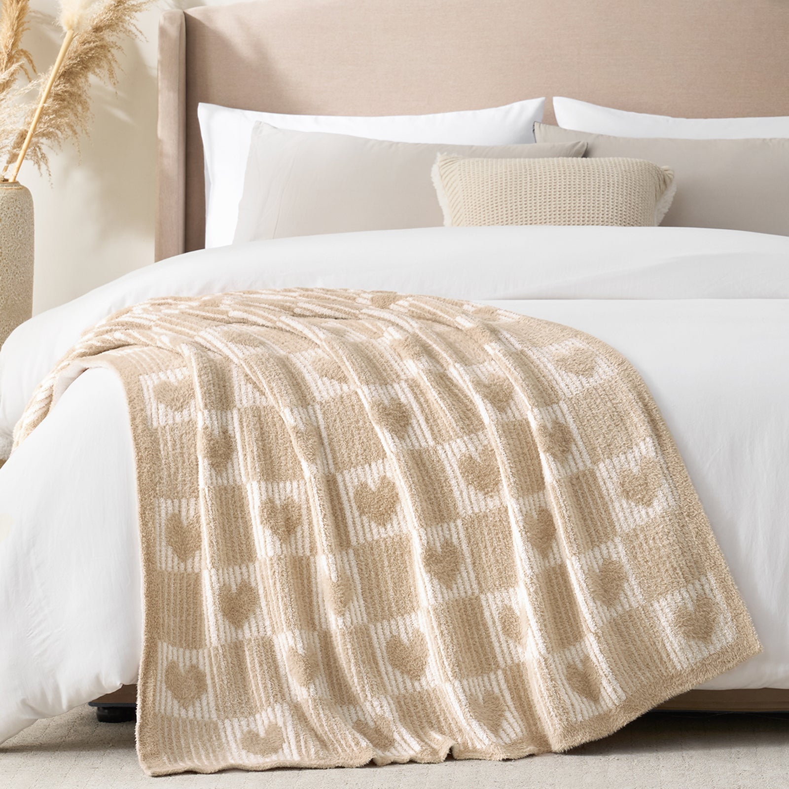 Snuggle Sacs Reversible Heart Feather Yarn Knit Throw Blanket on the bed in a bright room#color_Cream/Beige
