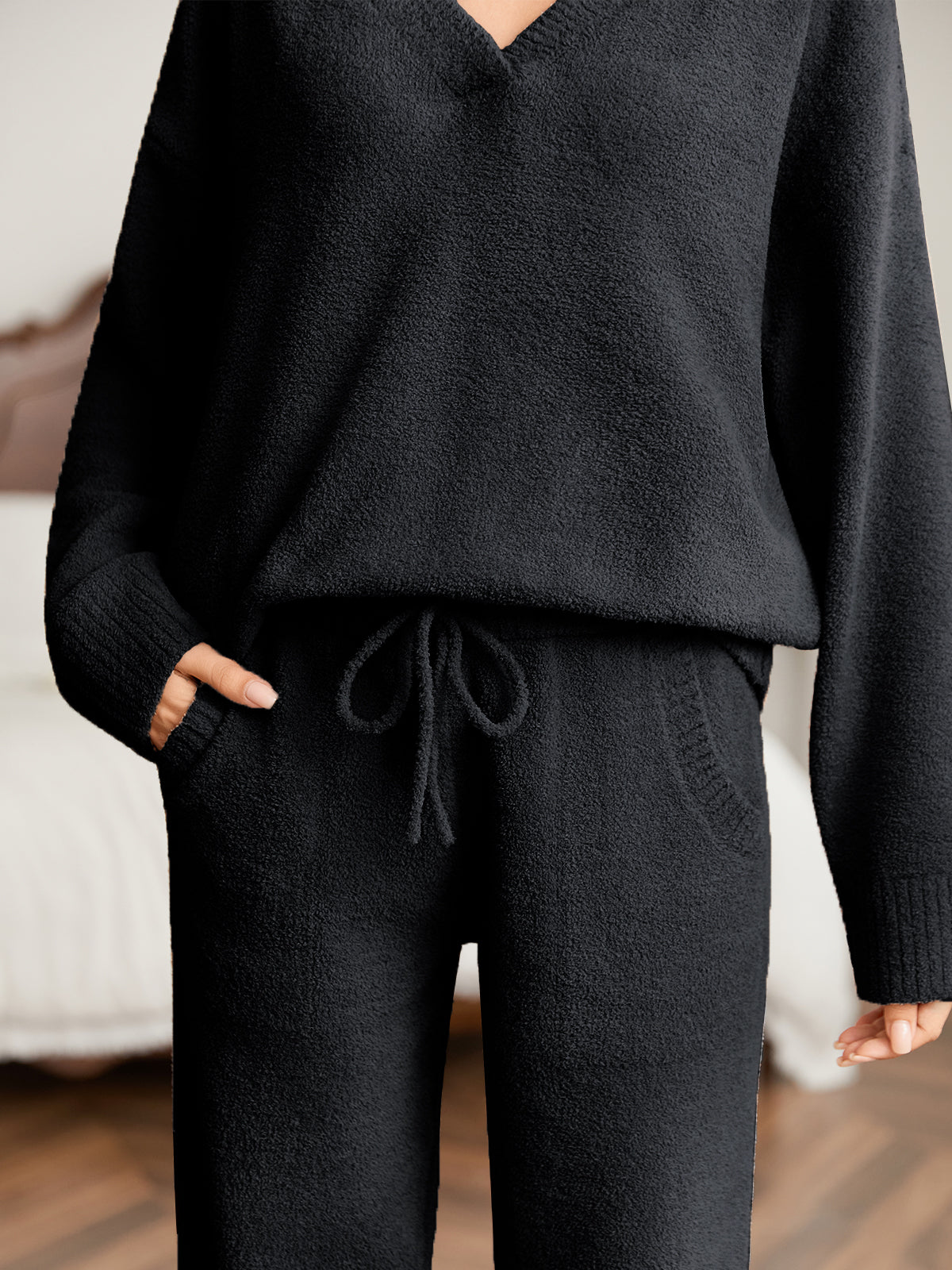 Close up of women long sleeve V-neck knit loungewear set in Black, showcasing drawstring waist and soft knit fabric #color_Black