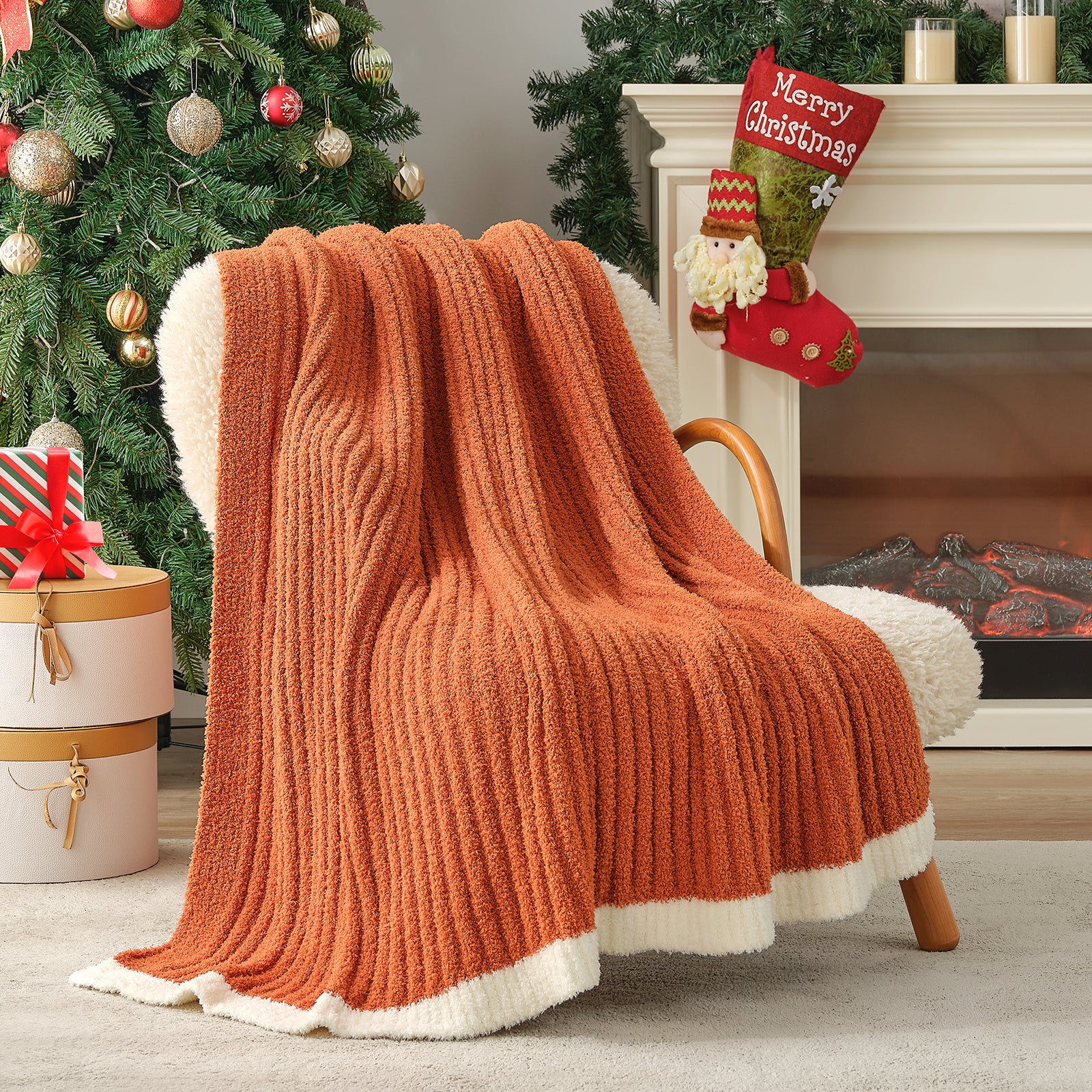 Orange knit blanket draped over a chair in a festive living room with Christmas decorations. #color_Burnt Orange
